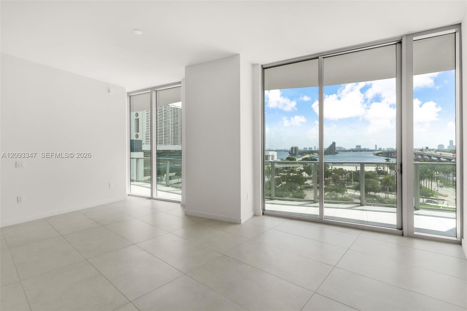Corner living room with floor to ceiling glass and Biscayne Bay views