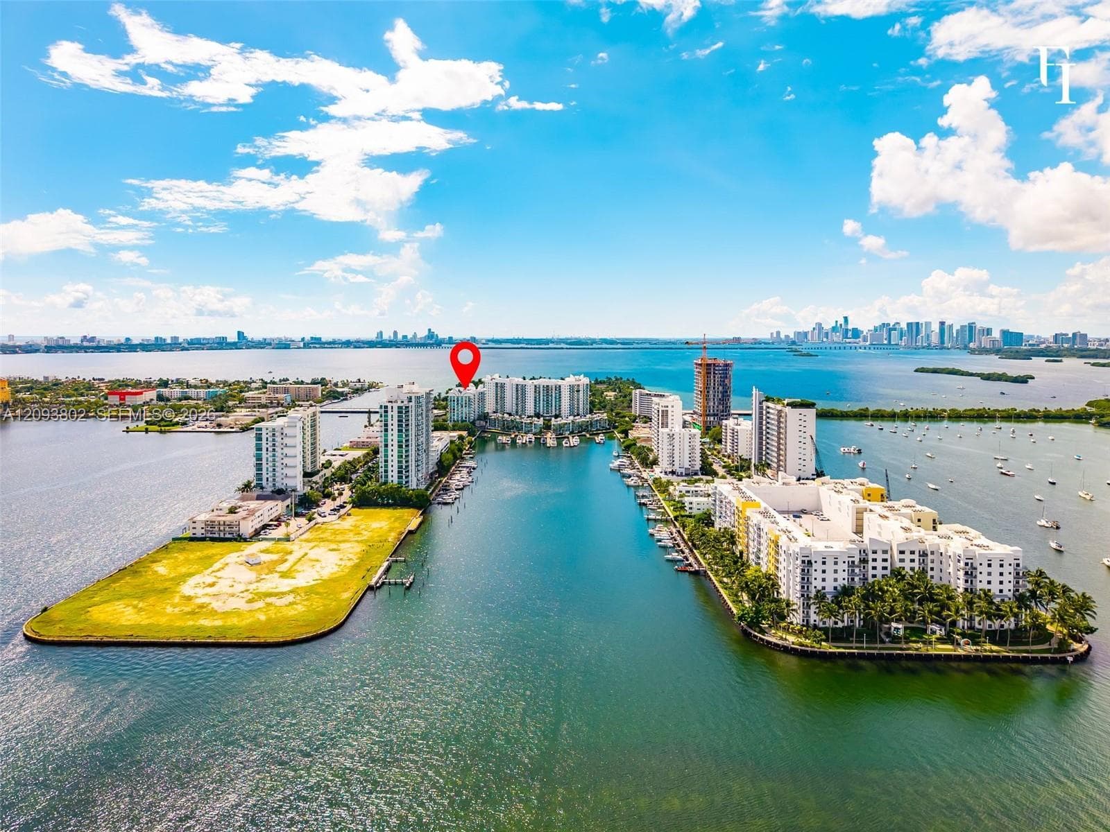 Waterfront mid-rise building featuring boat slips, direct harbor access, and a peninsula-style location