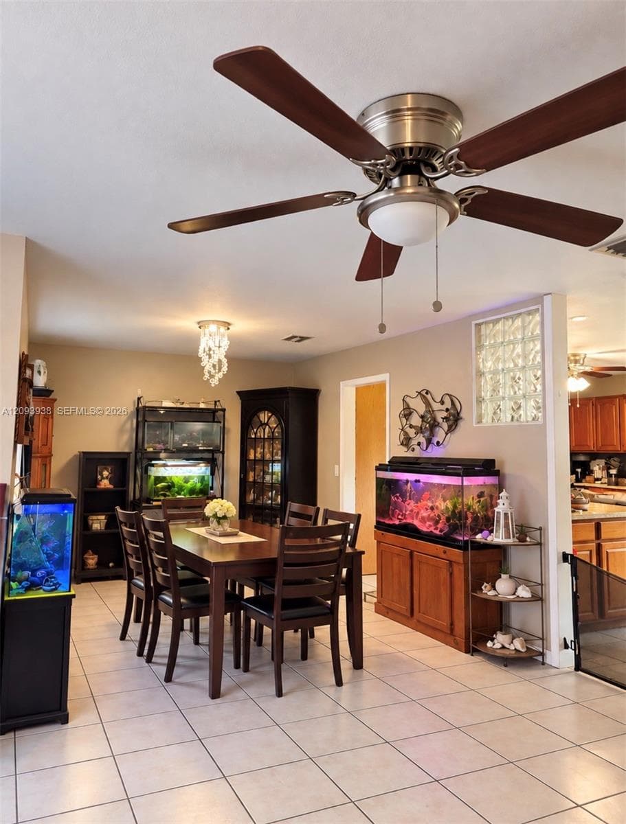 Ceramic tile flooring, brushed nickel ceiling fan with integrated lighting, and decorative glass block window accent