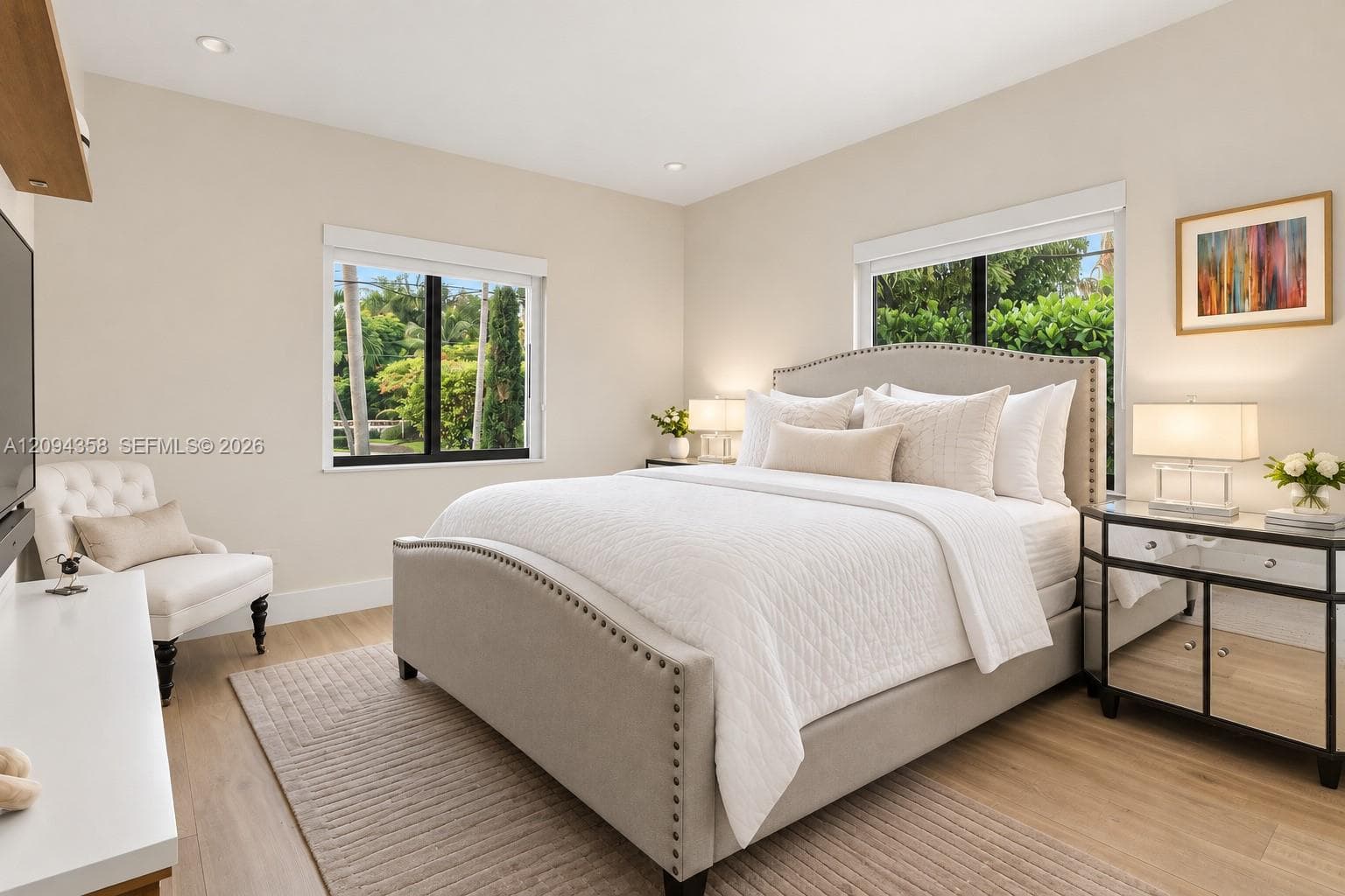 Room featuring wood-finish flooring, recessed lighting, and dual windows with black frames