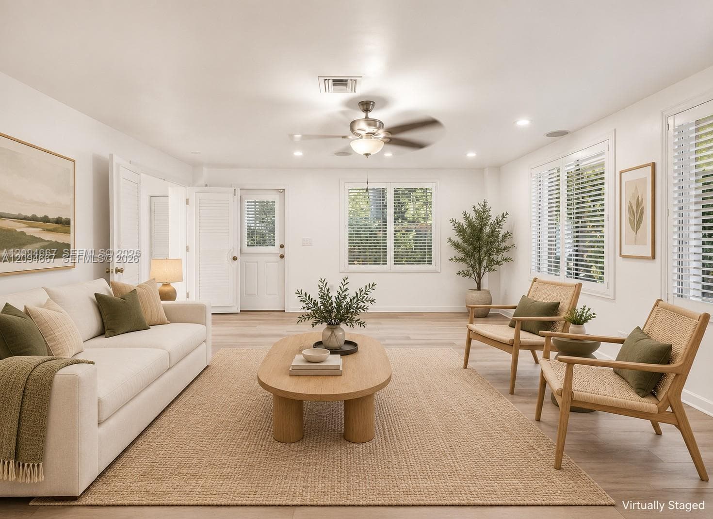 Living area featuring wood-finish flooring, recessed lighting, a brushed metal ceiling fan, and multi-pane windows with horizontal blinds