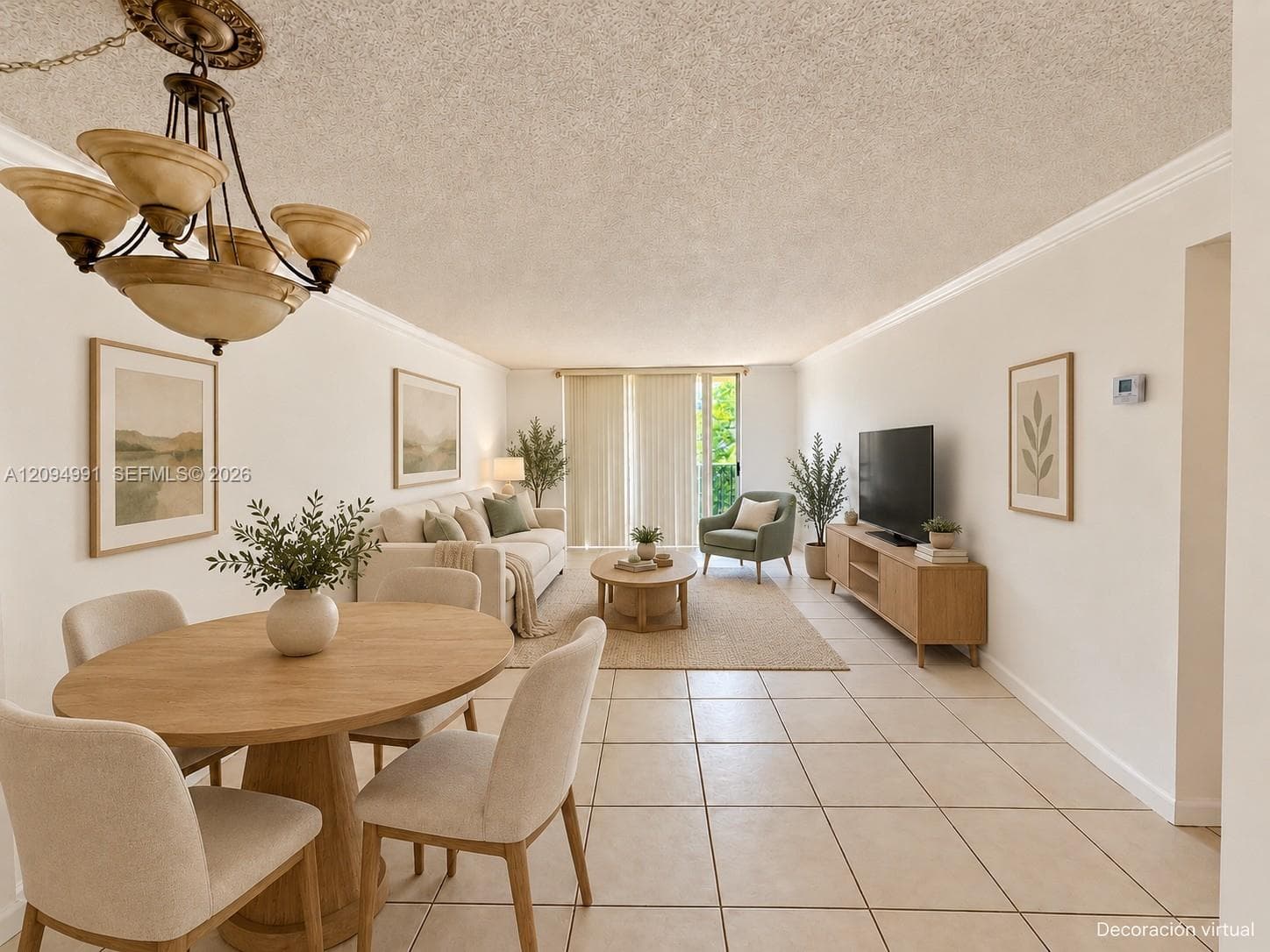 Open-concept interior featuring light-toned tile flooring, crown molding, a multi-arm chandelier with glass shades, and sliding glass doors