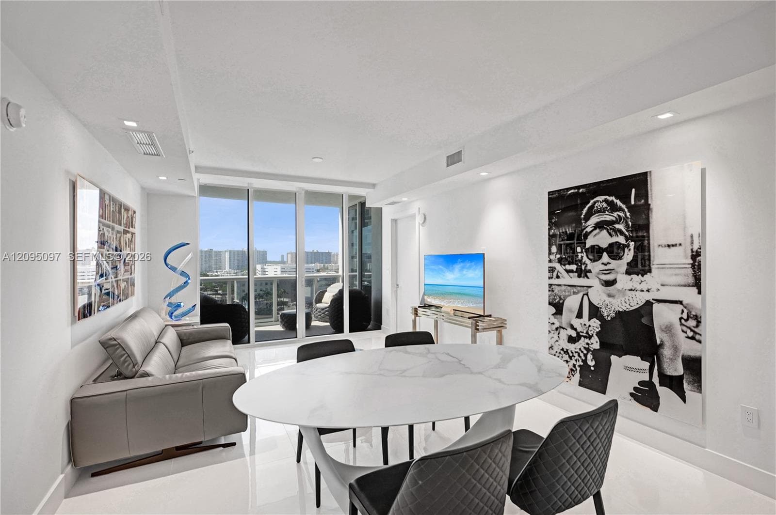 Floor-to-ceiling glass wall, polished tile flooring, recessed ceiling lighting, and private balcony access