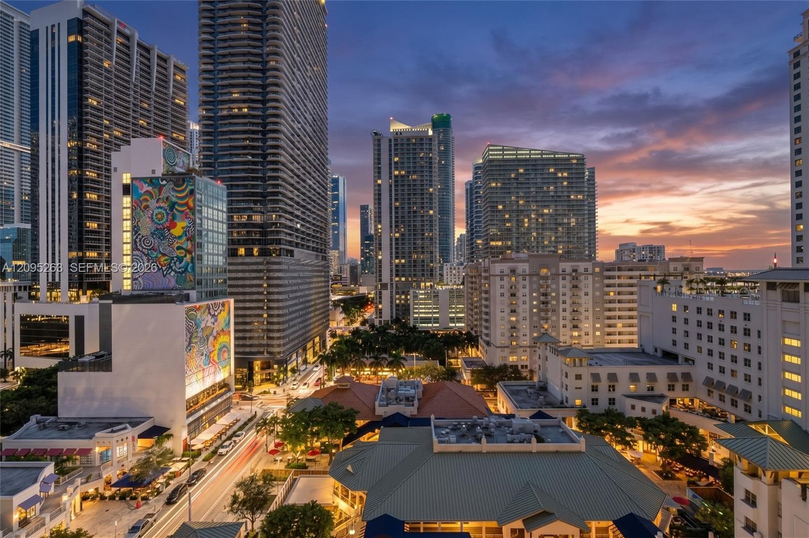 Virtual Twilight Aerial perspective of a high-density urban environment featuring multiple high-rise towers, multi-story masonry structures with terracotta-style roofing, and integrated public murals