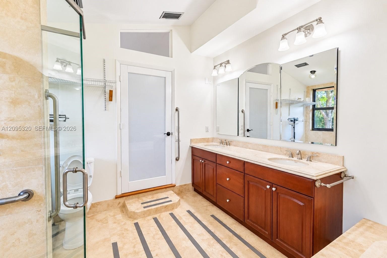 Dual vanity with integrated sinks, full-width mirror, and overhead lighting