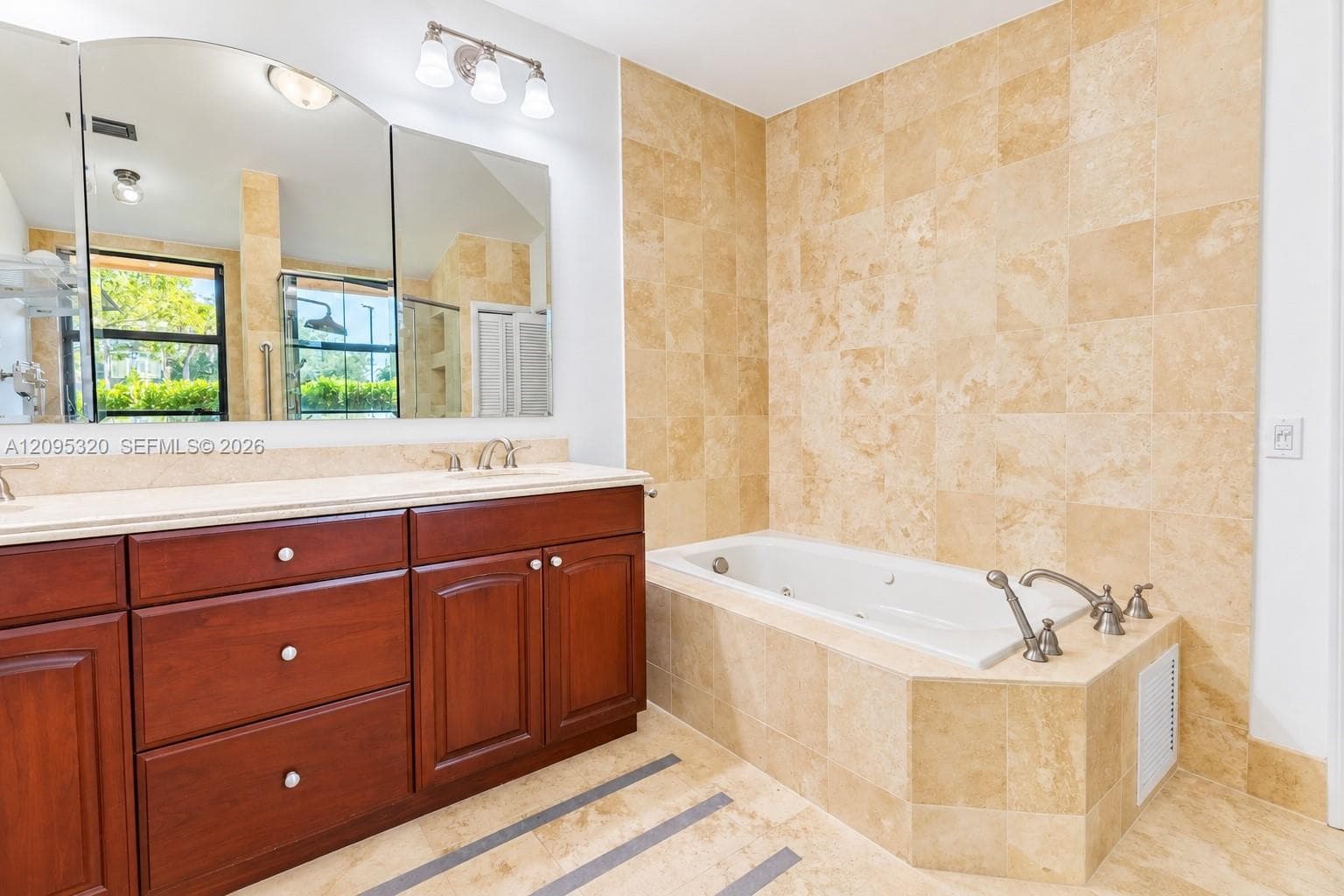 Dual vanity with wood cabinetry and undermount sinks