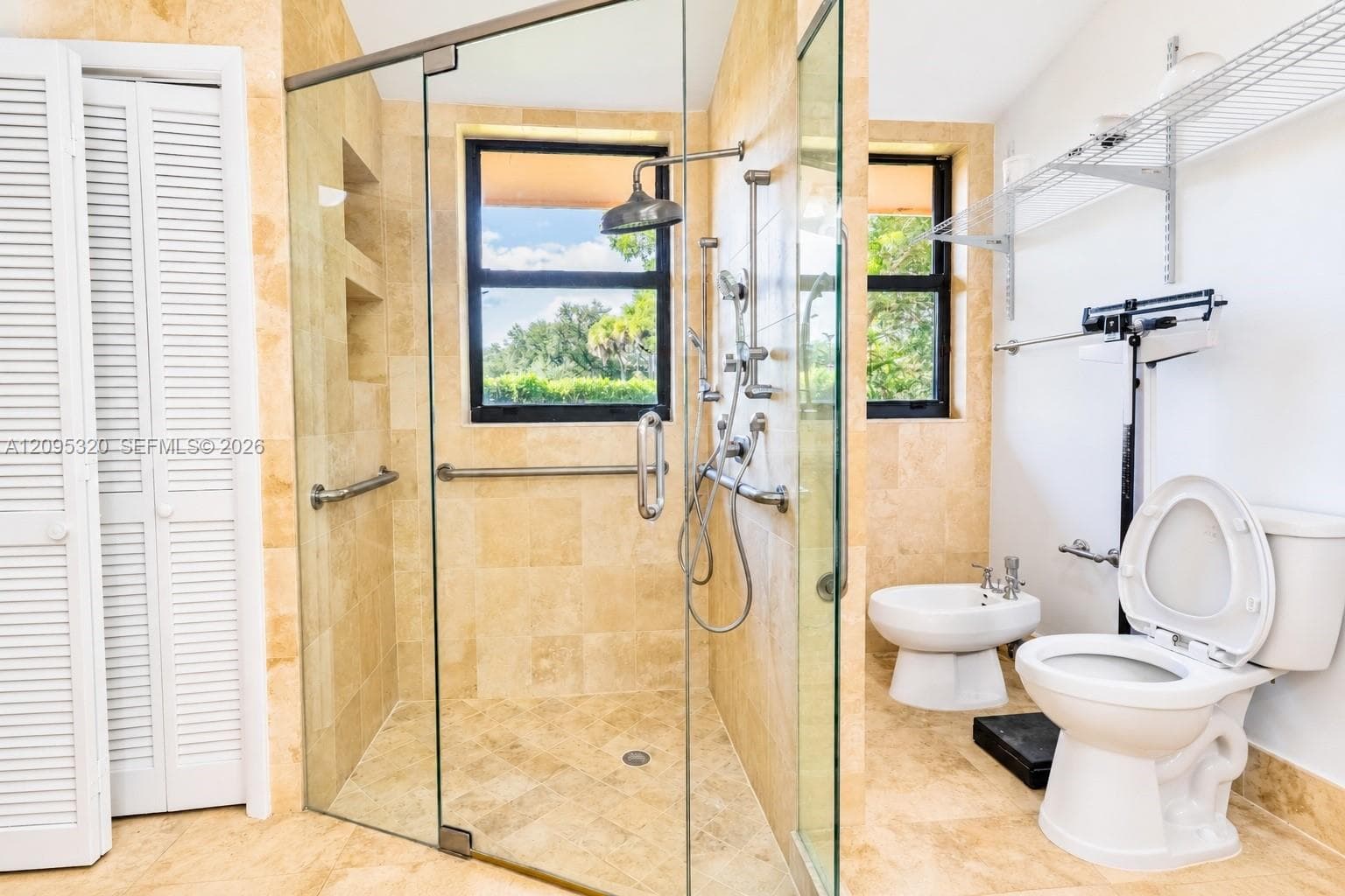 Spacious bathroom featuring a glass-enclosed shower with multiple showerheads, a bidet, and tiled walls and flooring