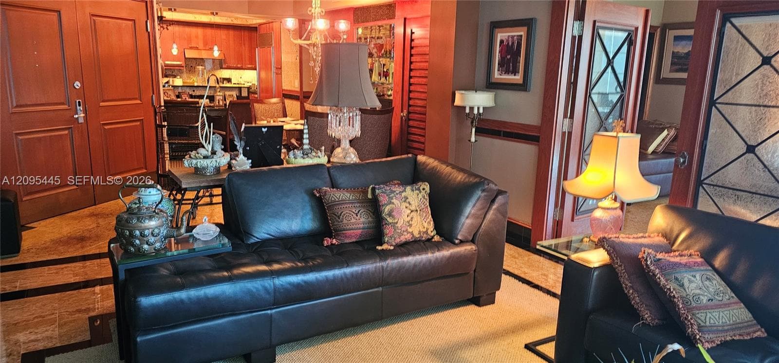 Polished stone flooring, custom wood-trim door casings, lattice-pane glass doors, and built-in decorative wood cabinetry