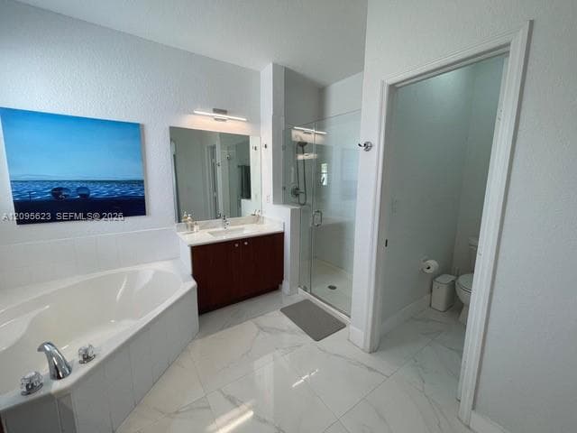 Spacious master bathroom with a bathtub and separate walk-in shower