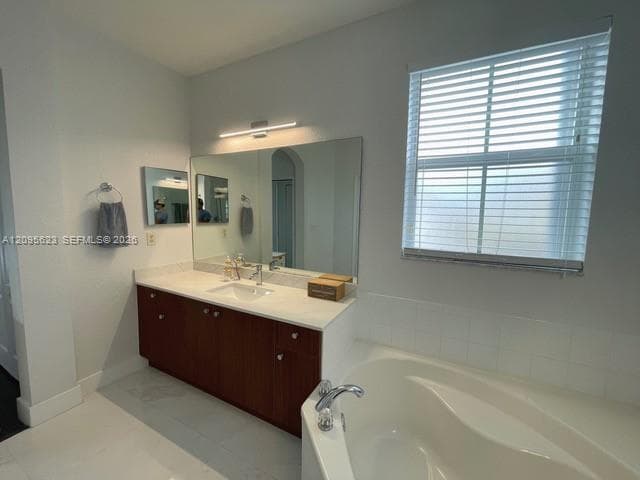 Upstairs shared bathroom with dual sinks, serving both bedrooms