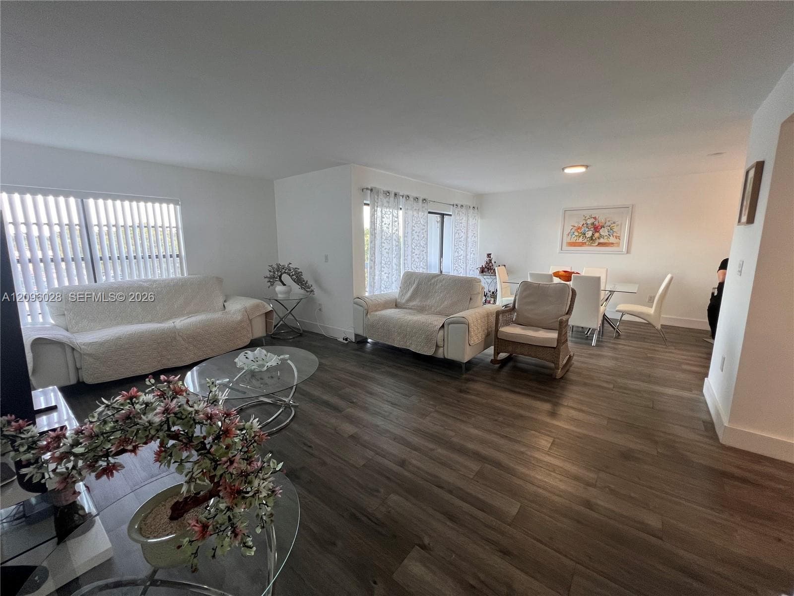 Open floor plan featuring wood-finish flooring, recessed lighting, and expansive windows