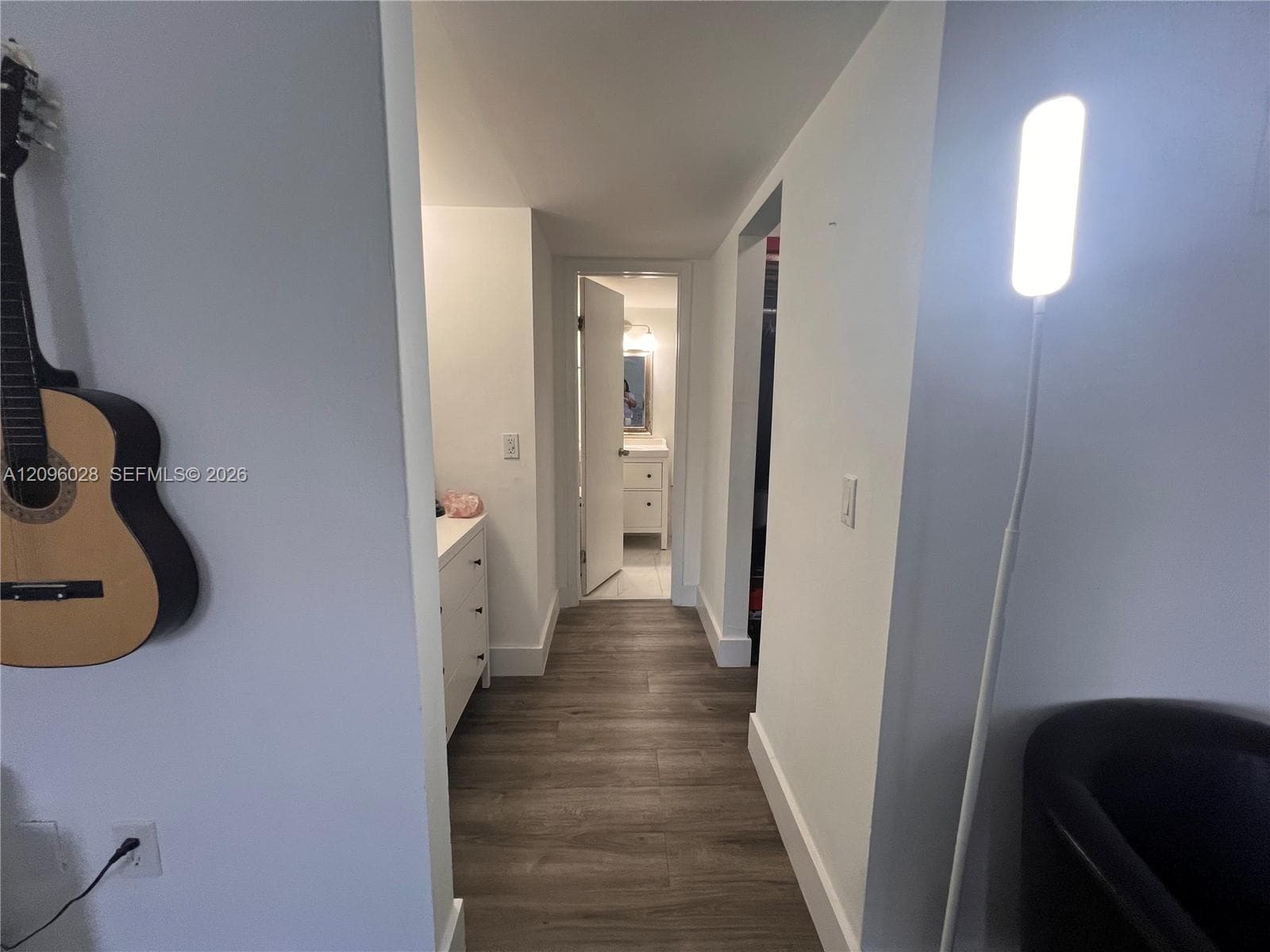 Interior hallway featuring wood-finish flooring and neutral-toned wall paint