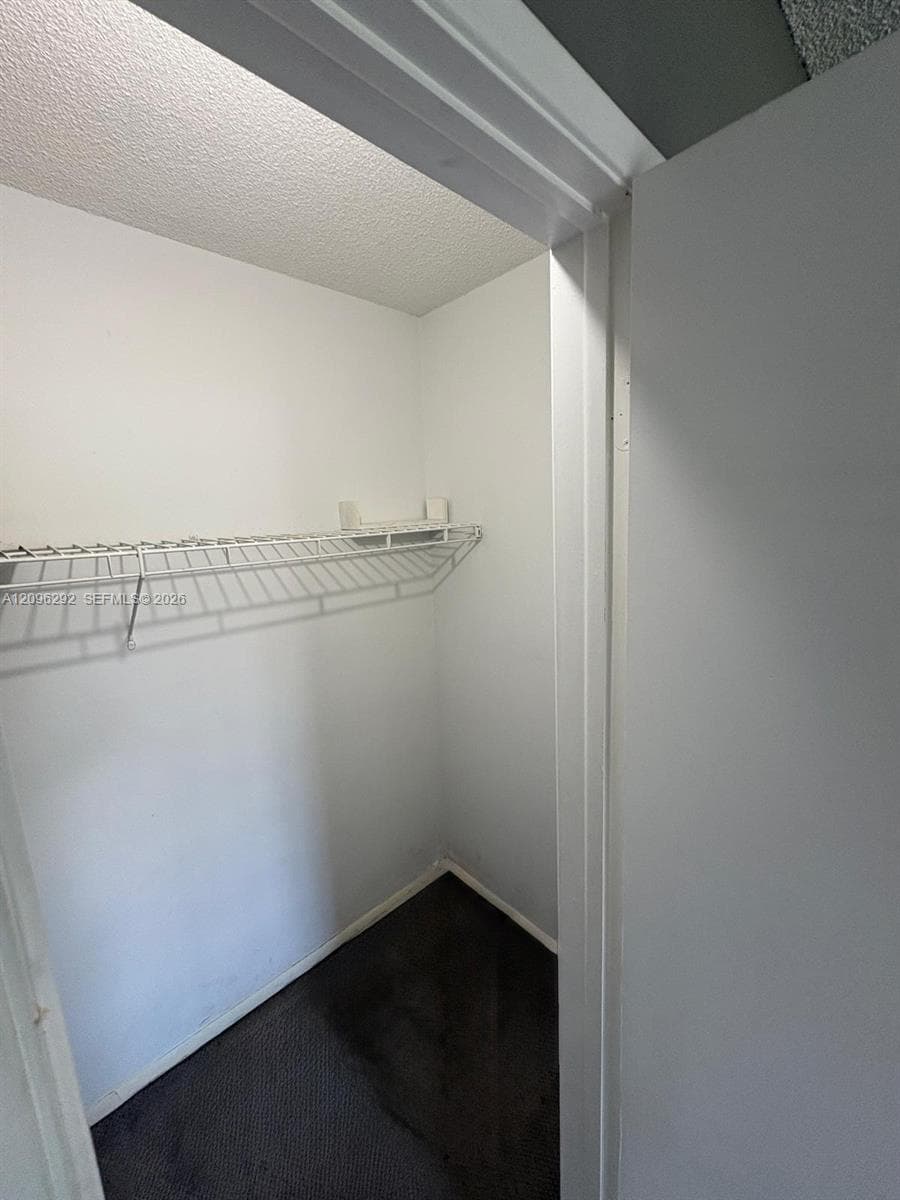 Storage space featuring white interior walls and installed wire shelving