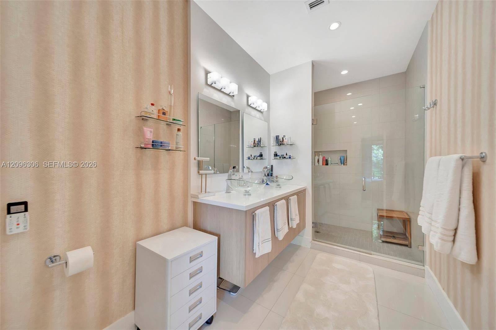 Primary bathroom with dual, vessel sinks, floating vanity and large walk-in shower