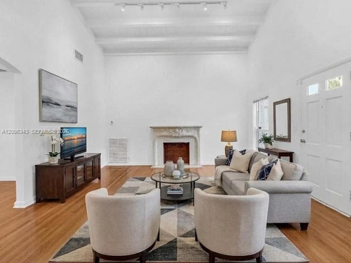Virtually Staged. Awesome living room with high ceilings and exposed beams. Great home for rent in Coconut Grove in Miami, FL. Enjoy large fenced yard, updated home in the North Grove.  Natoma Manors has 24/7 police patrol. Home for rent by Realtor. https://www.natomamanors.com/