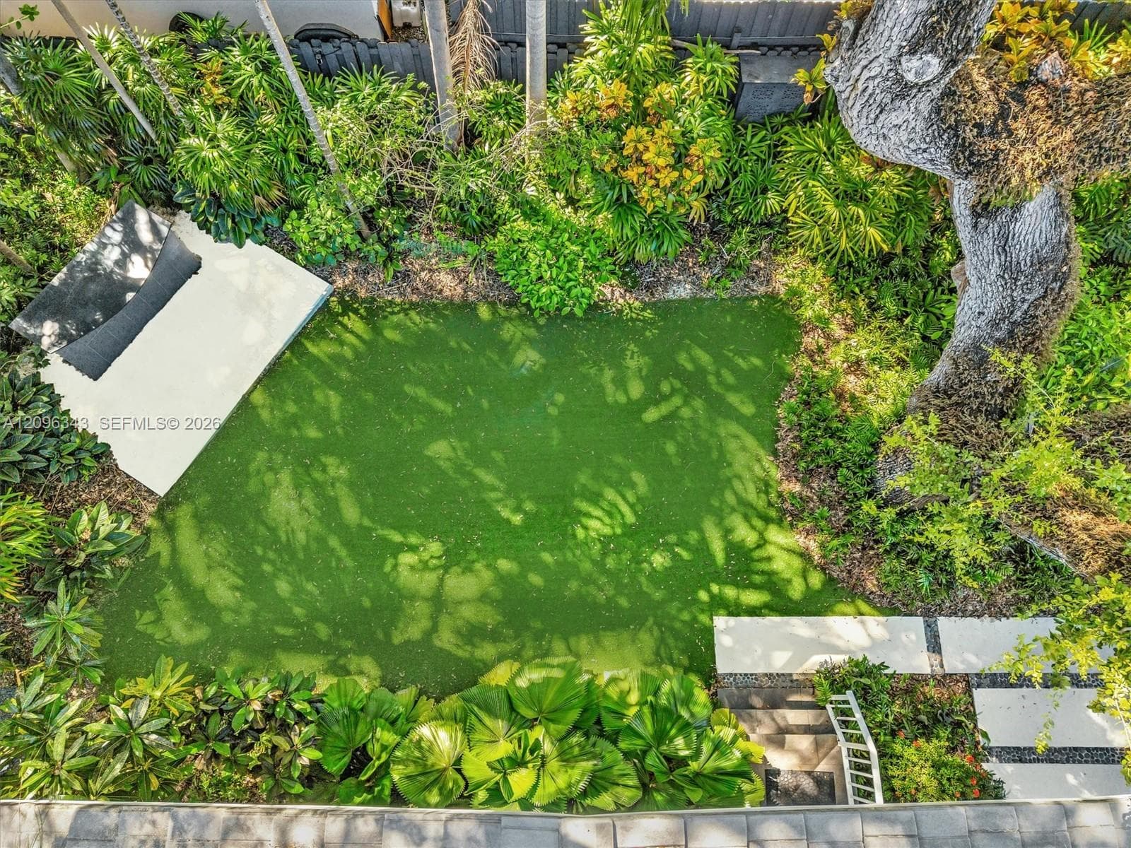 Landscaped gated yard with turf and built in bar for bbq in home for rent in Coconut Grove in Miami, FL. Enjoy this updated home in the North Grove.  Natoma Manors has 24/7 police patrol. Home for rent by Realtor.  House for rent in Coconut Grove. https://www.natomamanors.com/