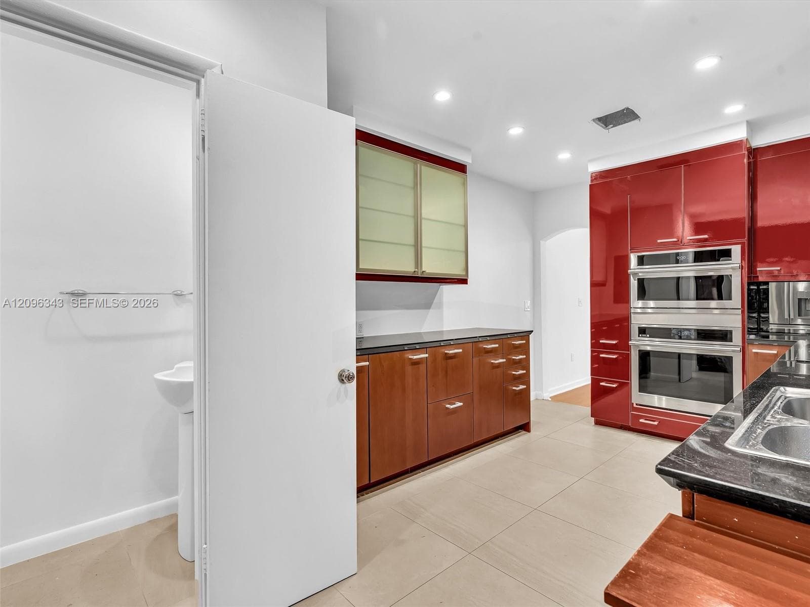 Stylish Poggenpohl kitchen with stainless steel appliances in home for rent in Coconut Grove in Miami, FL. Also showing bath. Updated rental in Natoma Manors has 24/7 police patrol. Home for rent by Realtor. https://www.natomamanors.com/