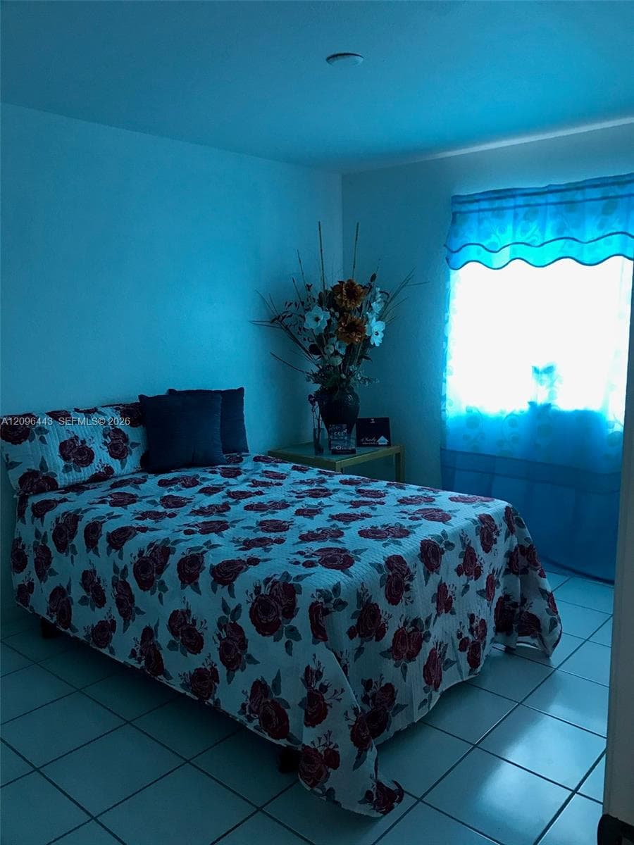 Interior space featuring neutral-toned walls and ceramic tile flooring