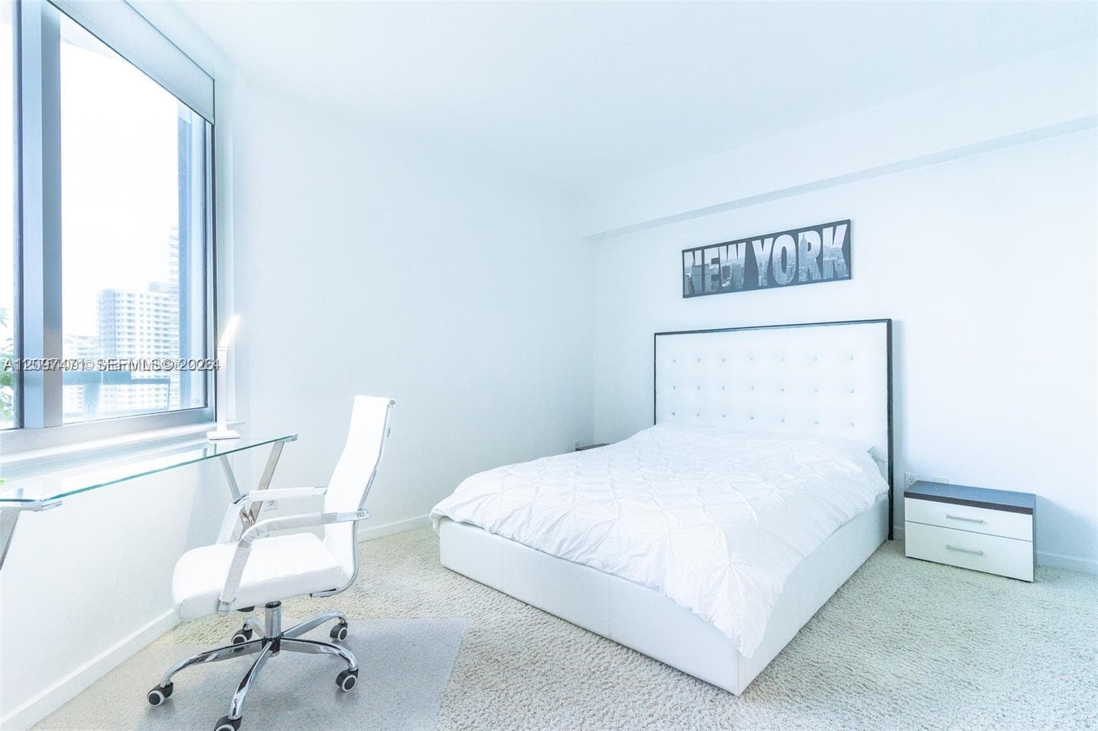 Floor-to-ceiling windows with expansive city exposure, wall-to-wall carpeting, and neutral interior finishes