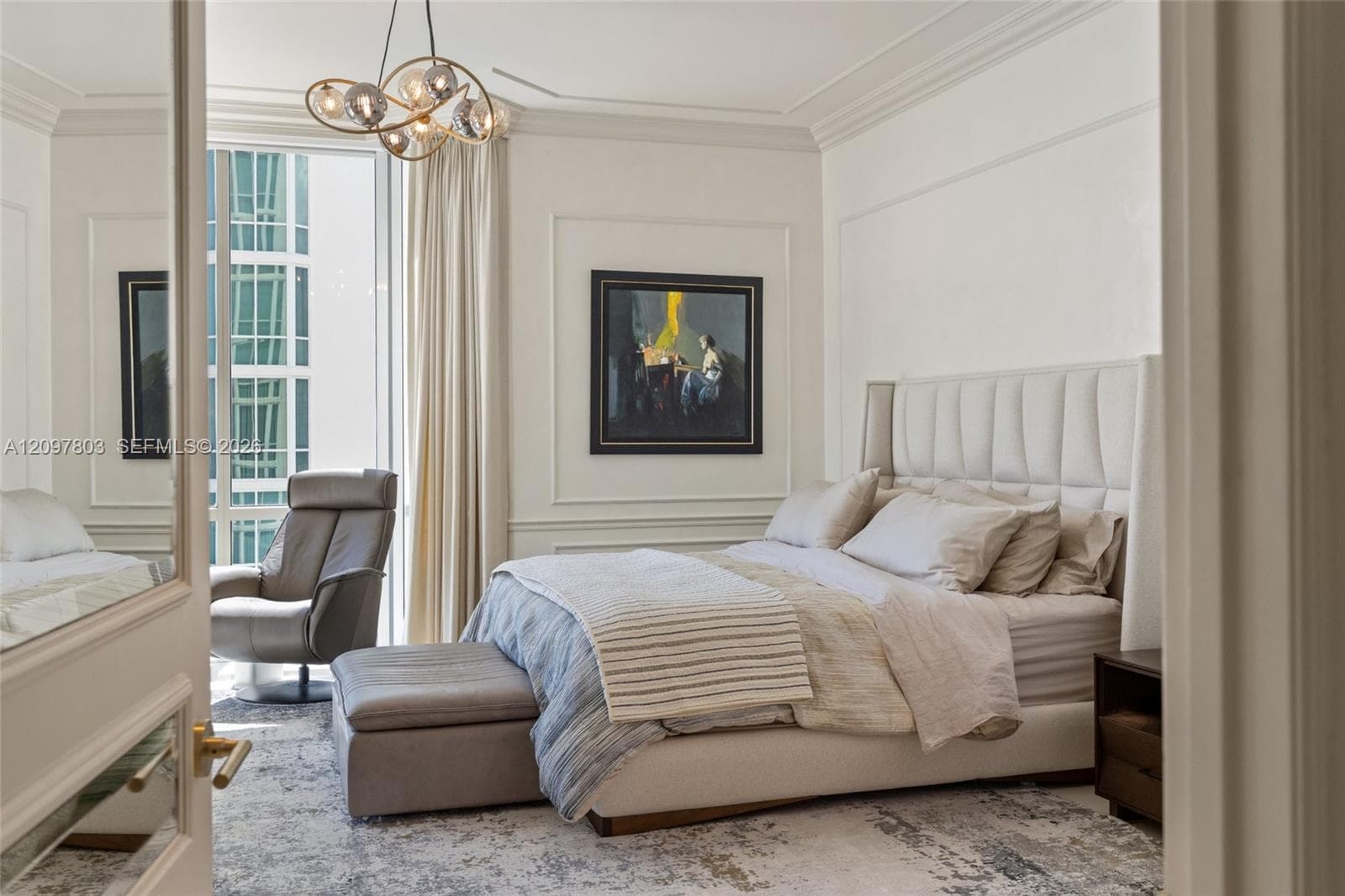 Room featuring decorative wall molding, a multi-globe pendant light fixture, crown molding, and floor-to-ceiling windows