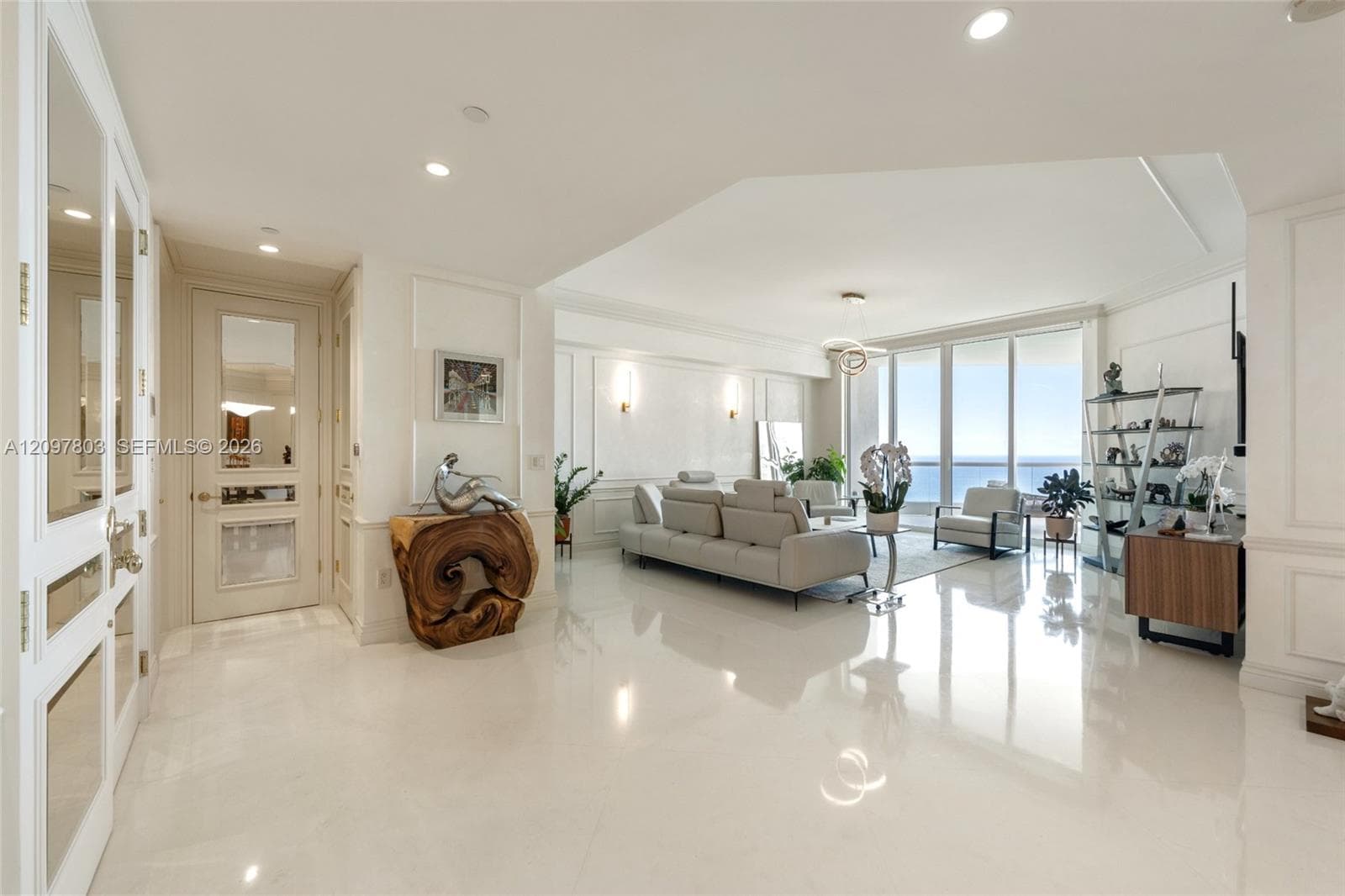 Polished stone flooring, floor-to-ceiling windows, custom wainscoting, recessed lighting, and glass-paneled interior doors