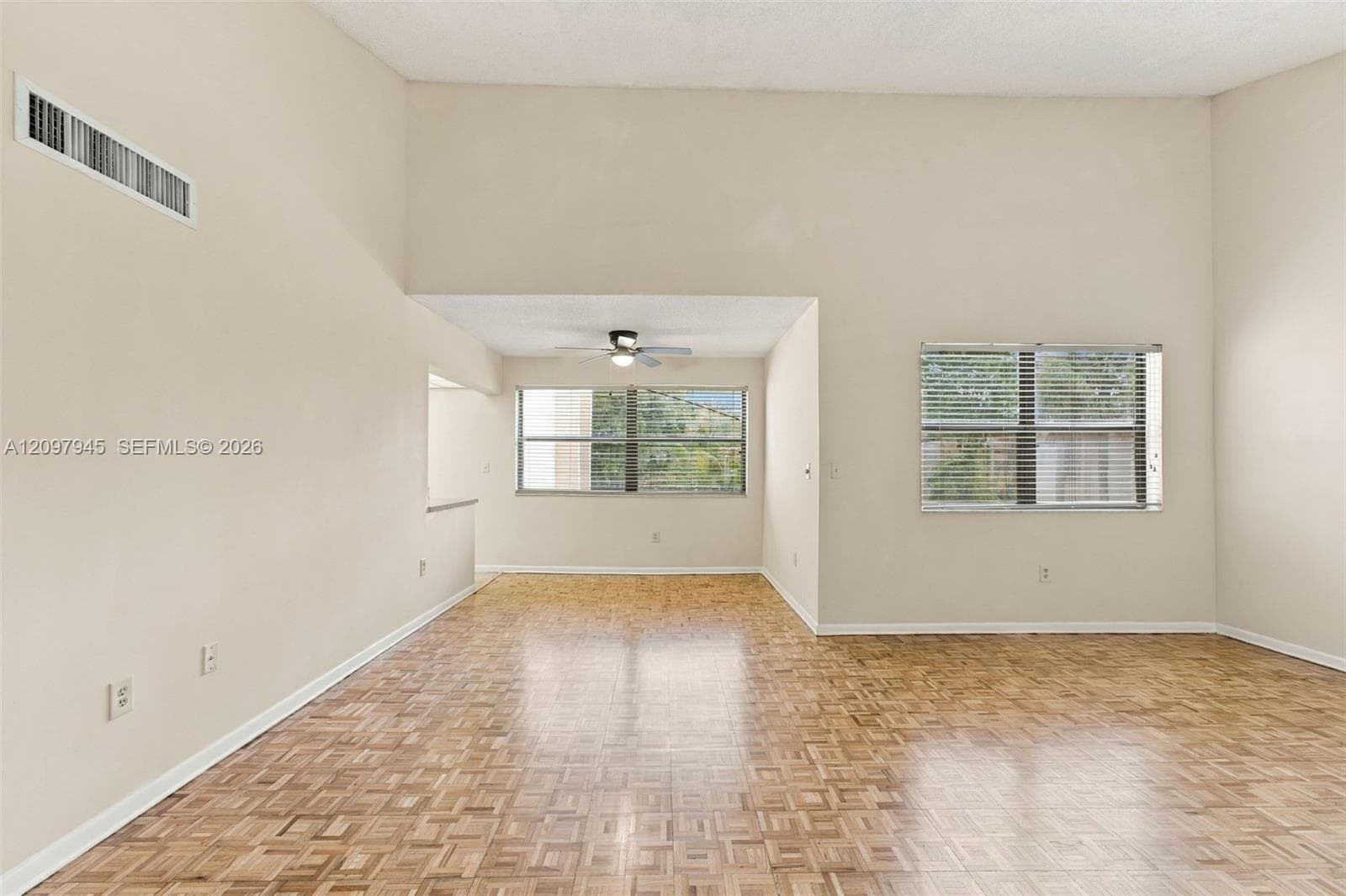 Vaulted ceilings, parquet wood-finish flooring, and horizontal sliding windows