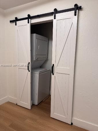 White sliding barn doors featuring matte black hardware, paired with wood-finish flooring