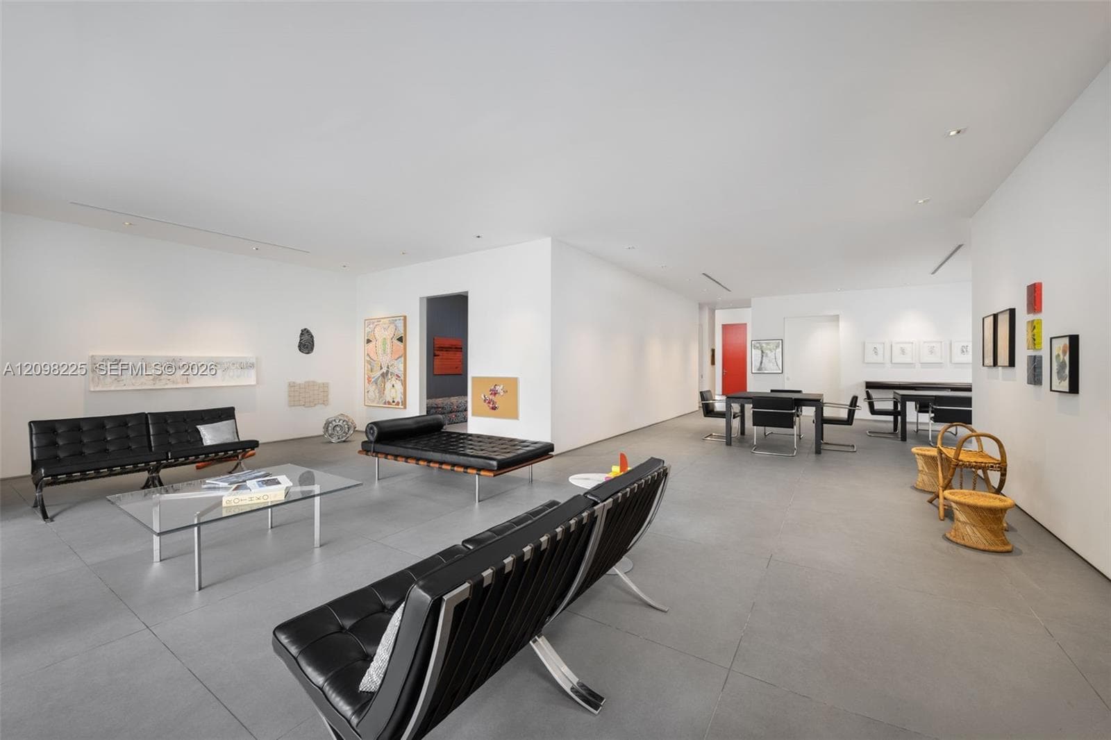 Open-concept interior featuring large-format neutral tile flooring, smooth wall finishes, and recessed ceiling lighting