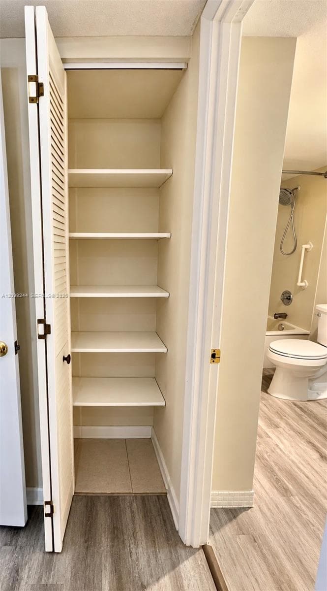 Built-in storage closet with louvered bi-fold doors and five fixed shelves