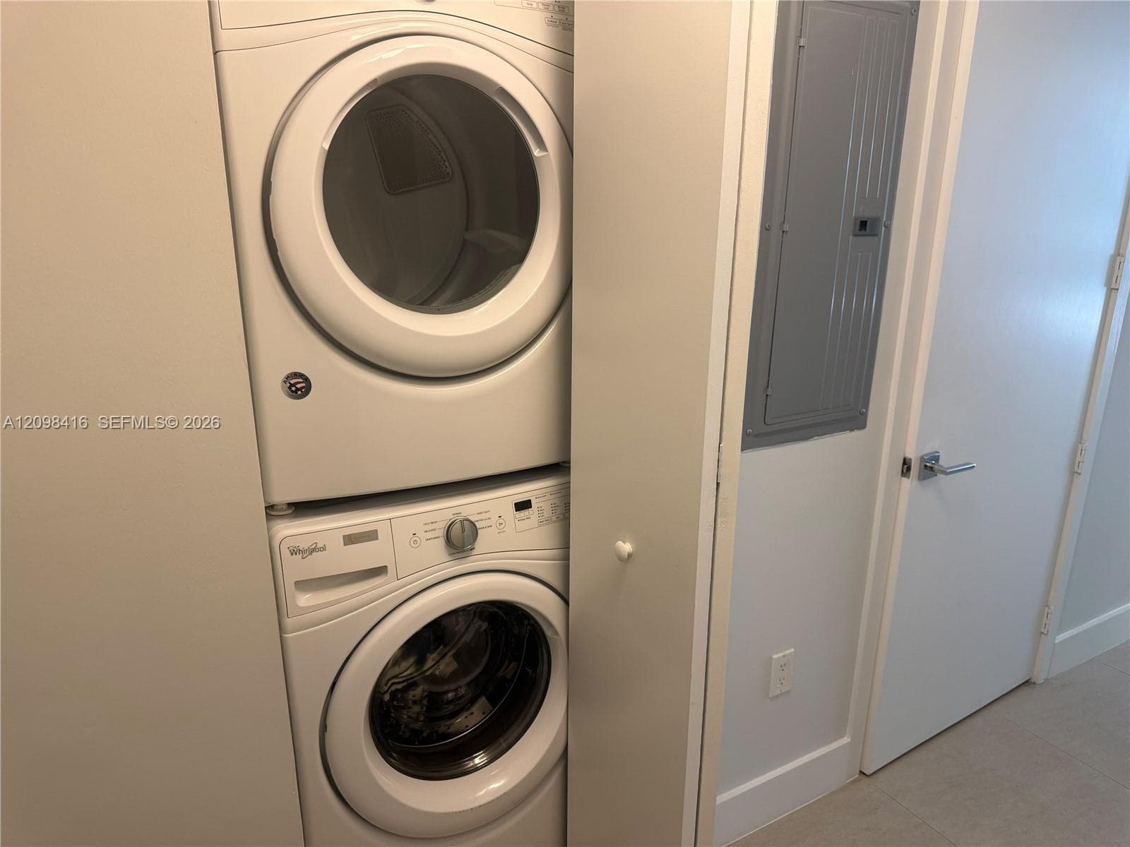 Stackable washer and dryer unit within a dedicated closet