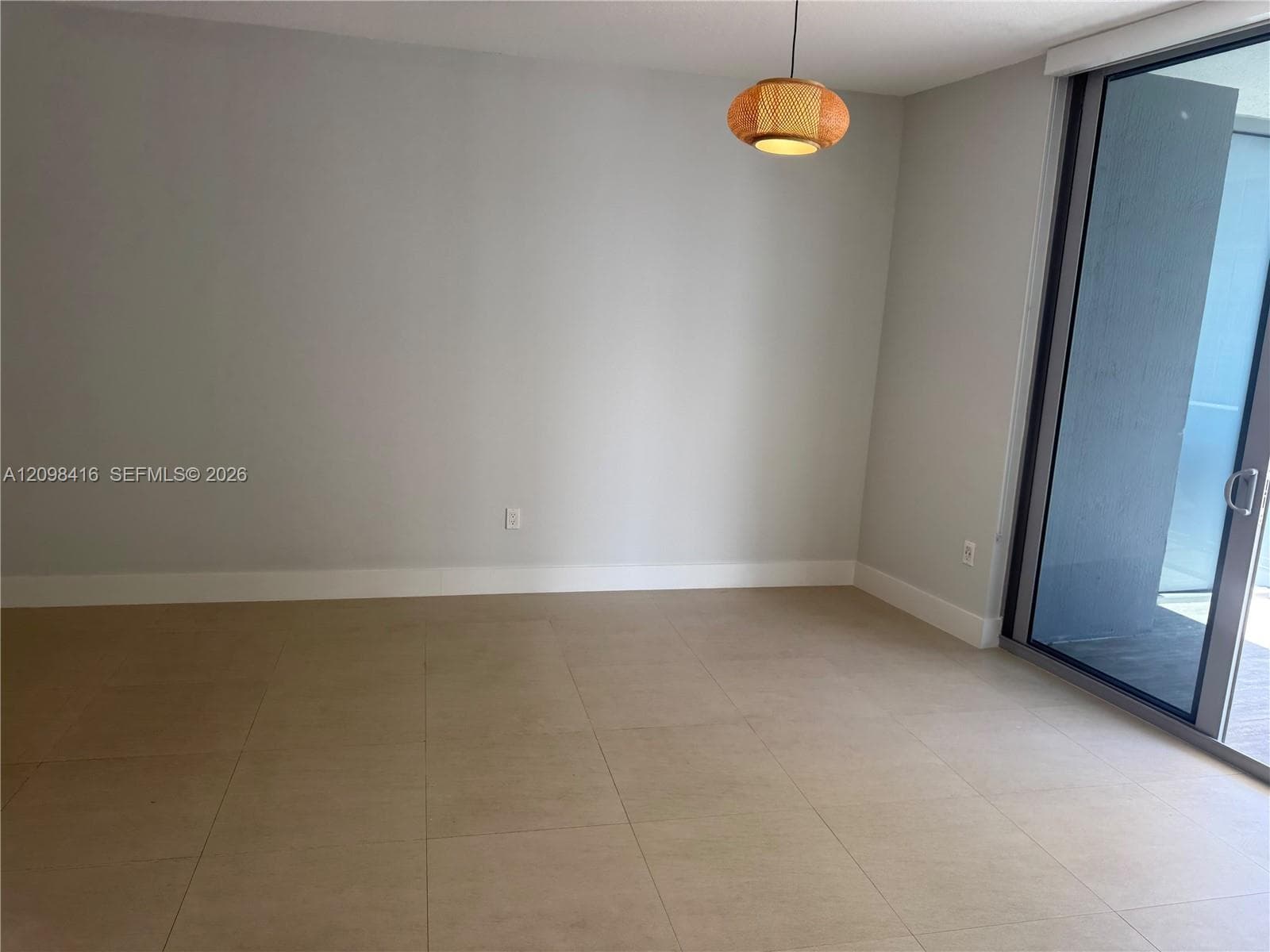 Smooth wall finishes, light-toned tile flooring, and a contemporary pendant light fixture