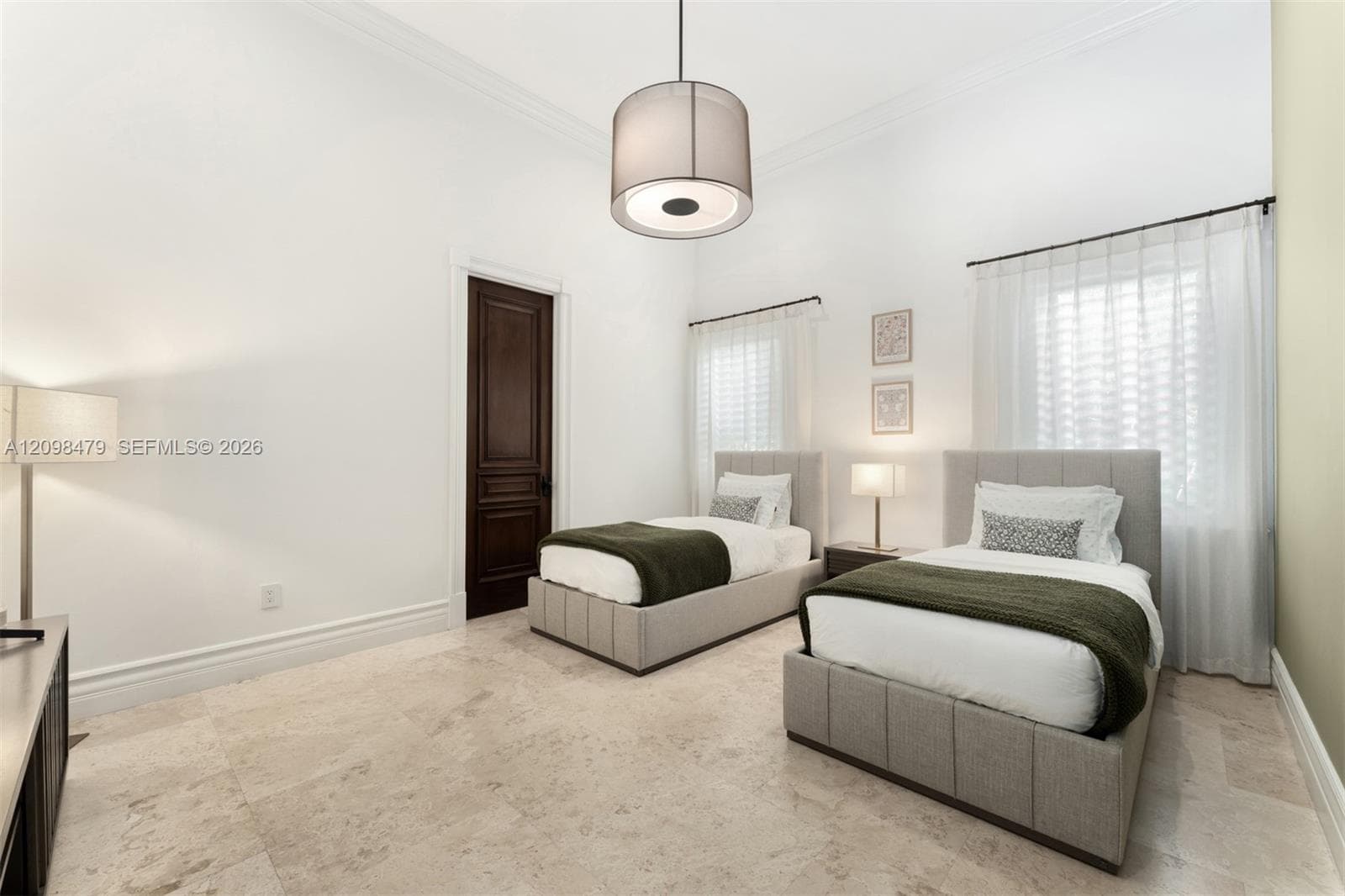Recessed lighting and a drum pendant fixture illuminate the space