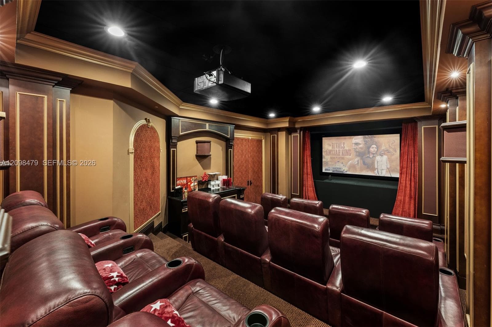 Dedicated home theater featuring a large projection screen, integrated projector, and recessed lighting