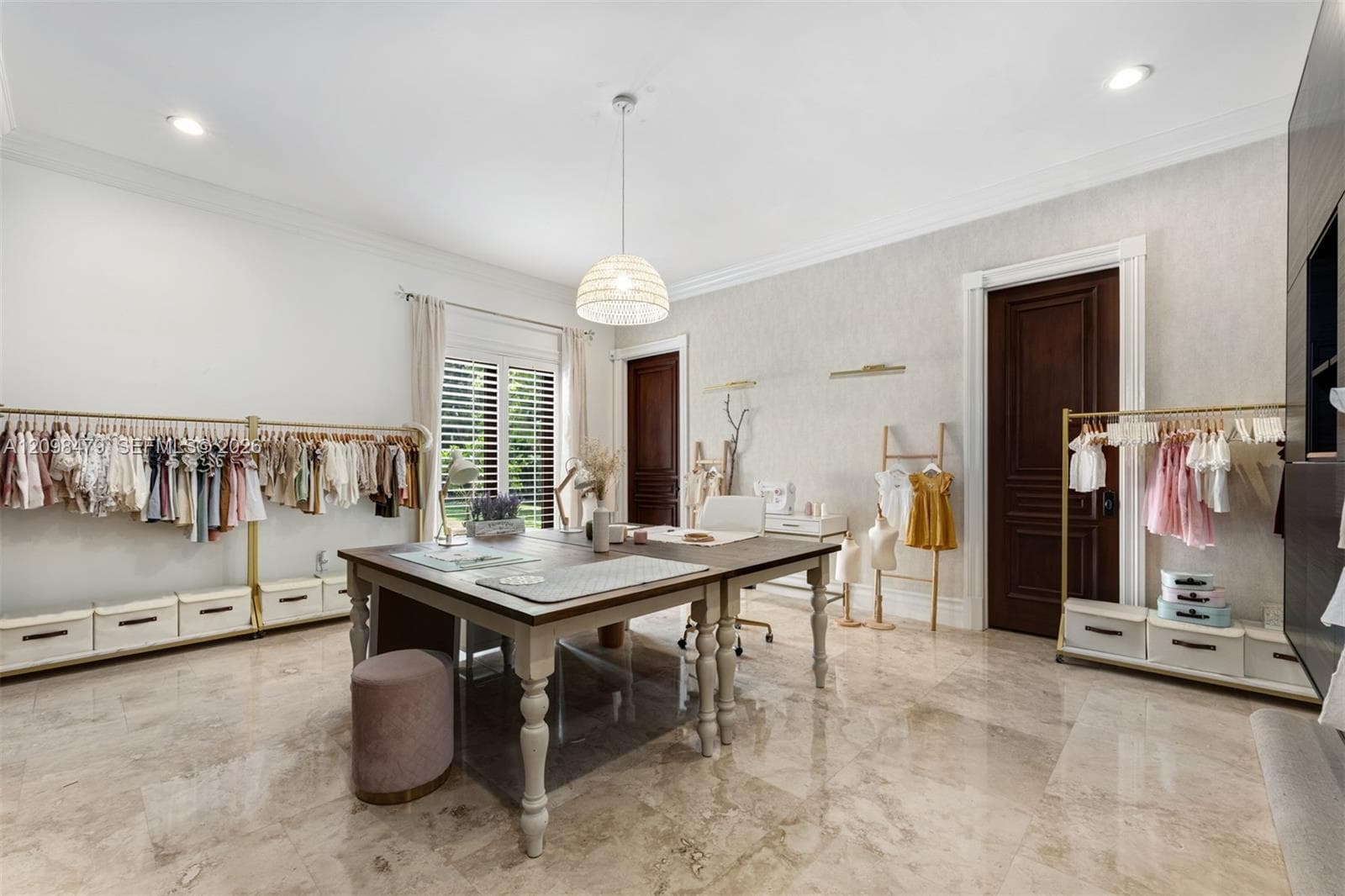 Recessed lighting, chandelier, wood-finish doors, window with plantation shutters, and polished stone flooring