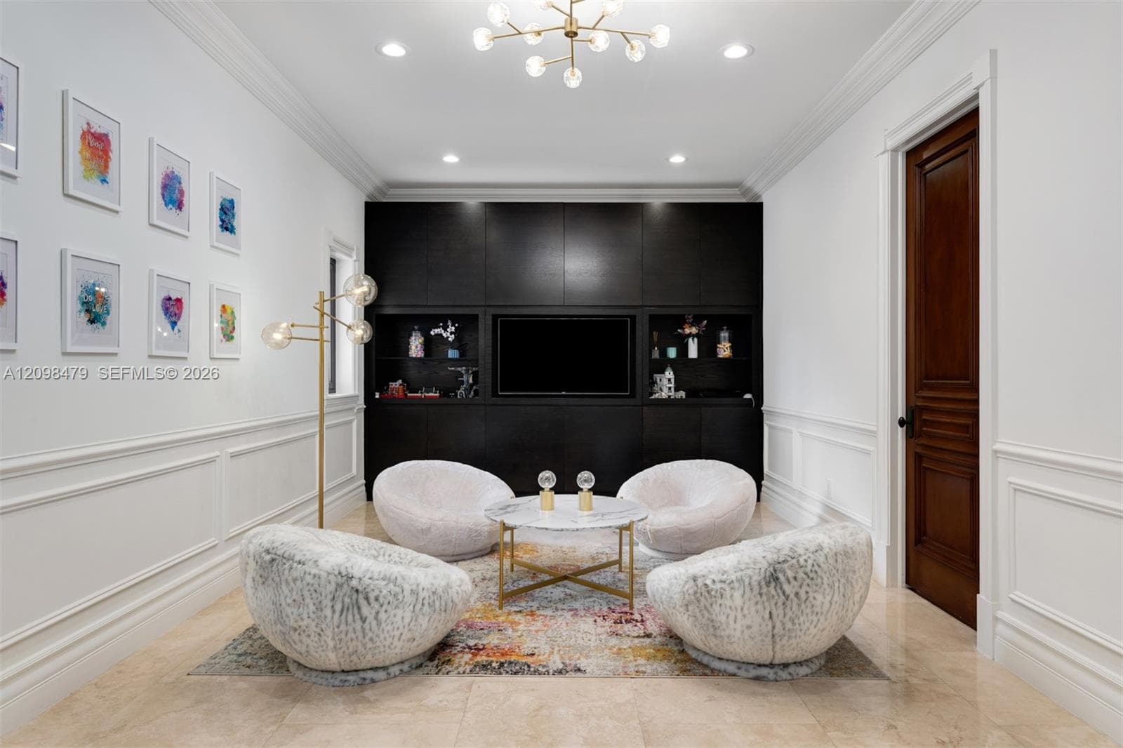 Recessed lighting with a modern chandelier, dark wood-finish built-in cabinetry, elegant wainscoting, and large format tile flooring