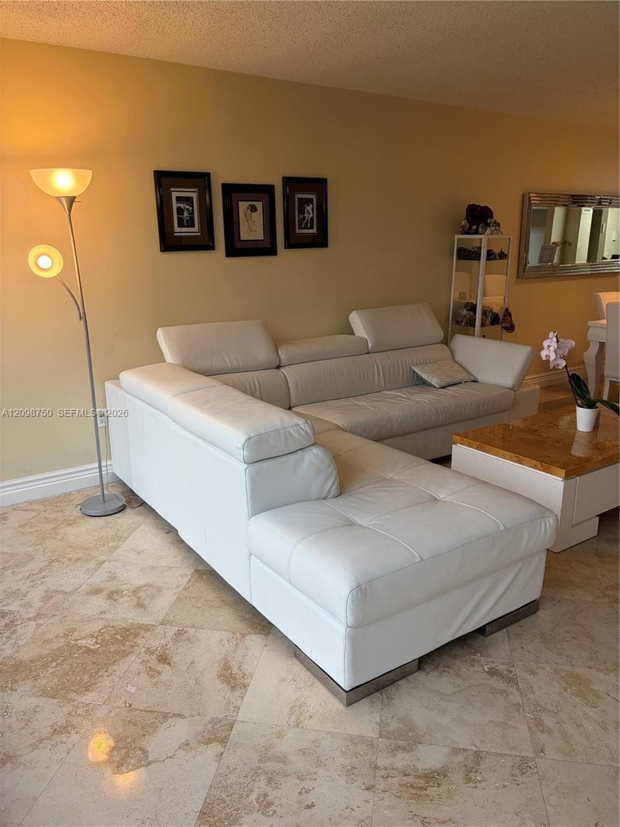 Neutral-toned natural stone flooring featuring a polished finish