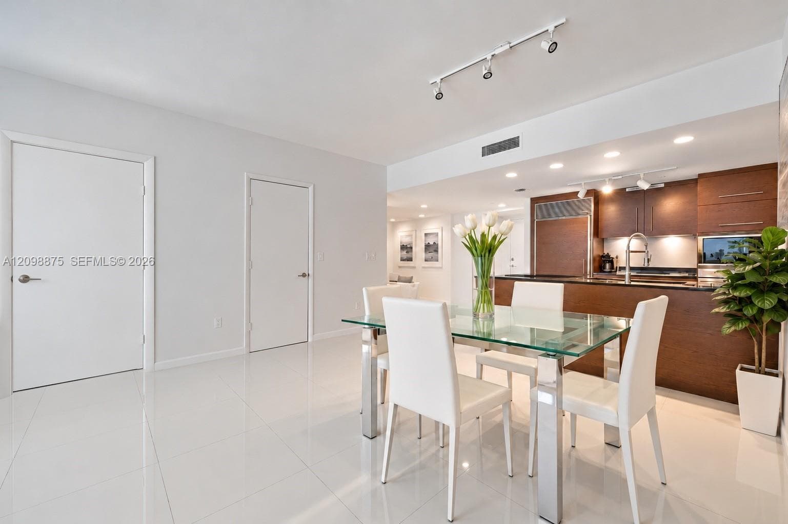 Open-concept dining area featuring polished tile flooring, recessed lighting, and track lighting