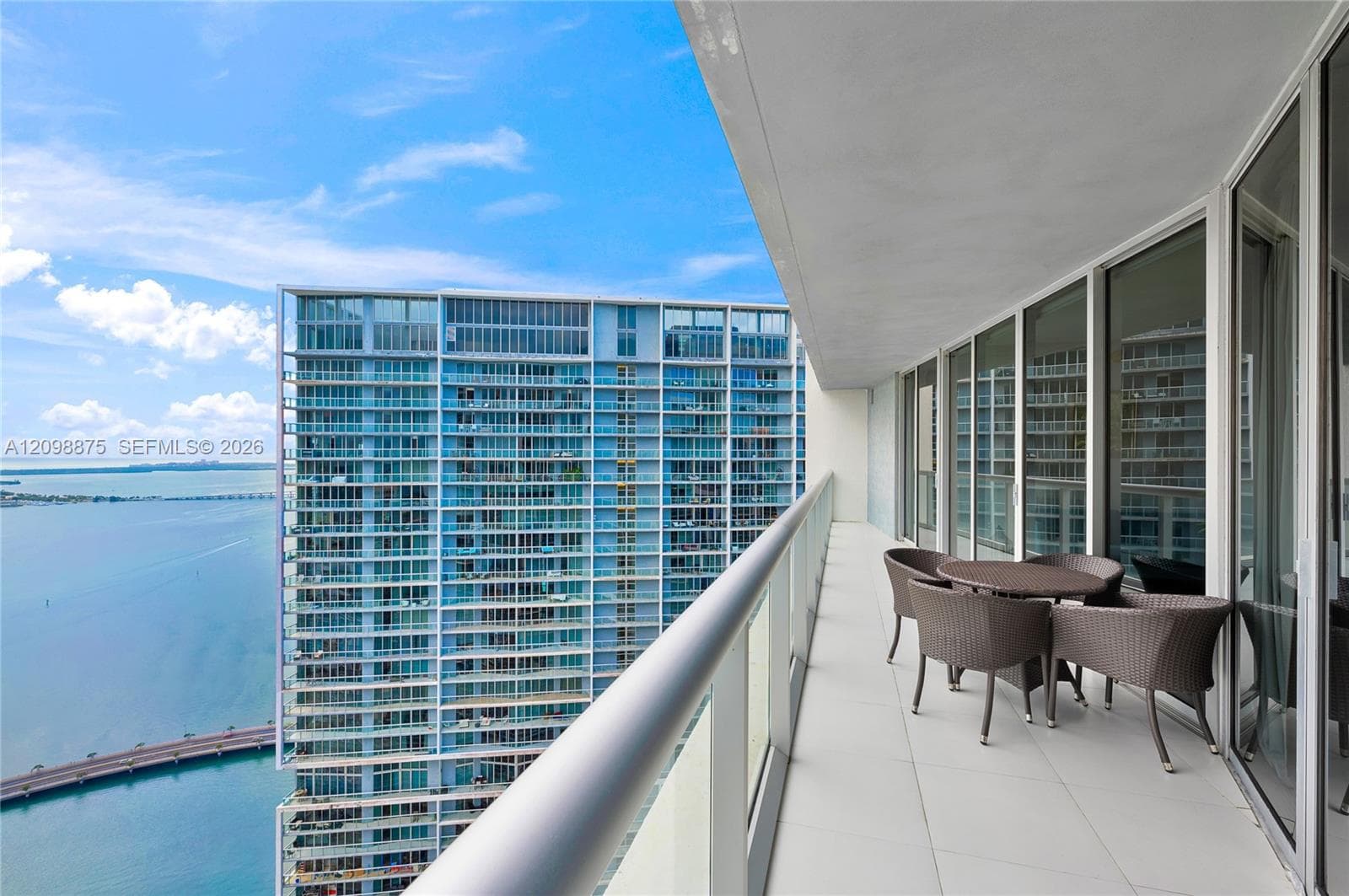 Expansive balcony with tiled flooring and a glass railing