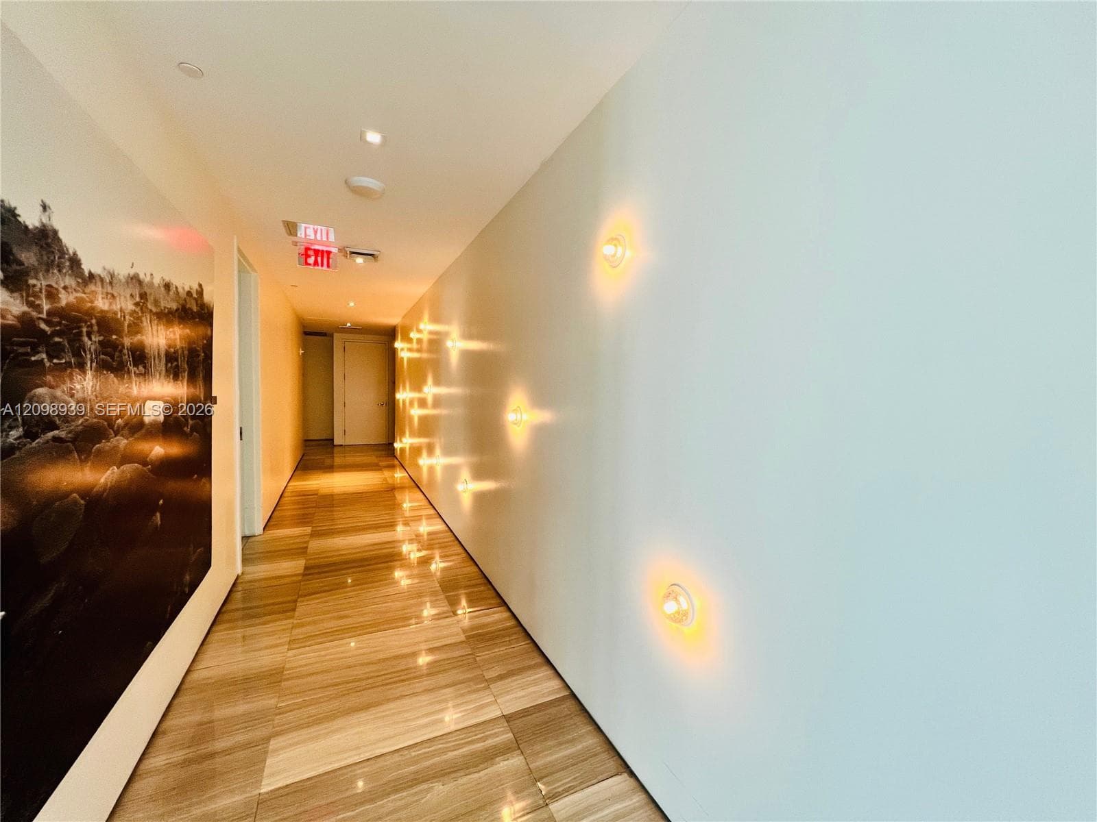 Striped tile flooring, recessed ceiling lighting, and wall-mounted sconces