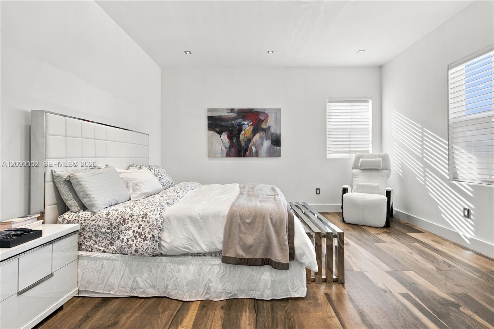Wood-finish flooring, recessed lighting, and horizontal window blinds