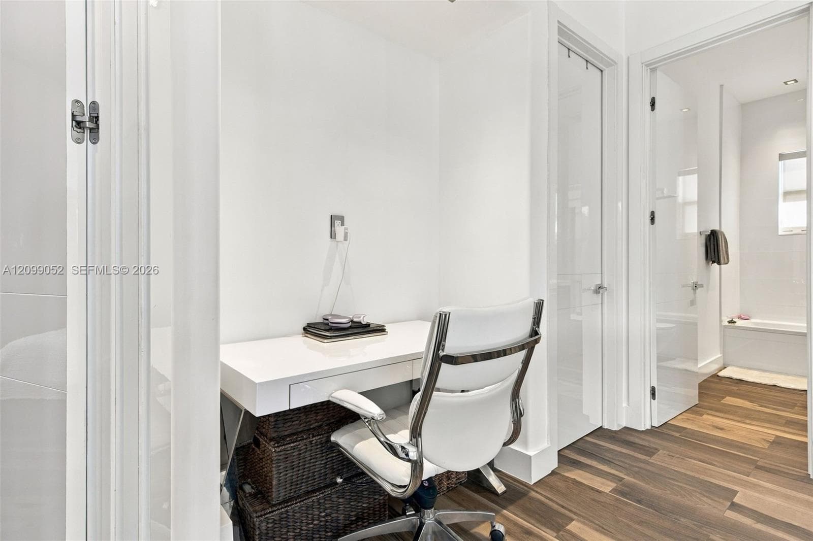 Built-in white desk with drawer storage, recessed lighting, and wood-finish flooring