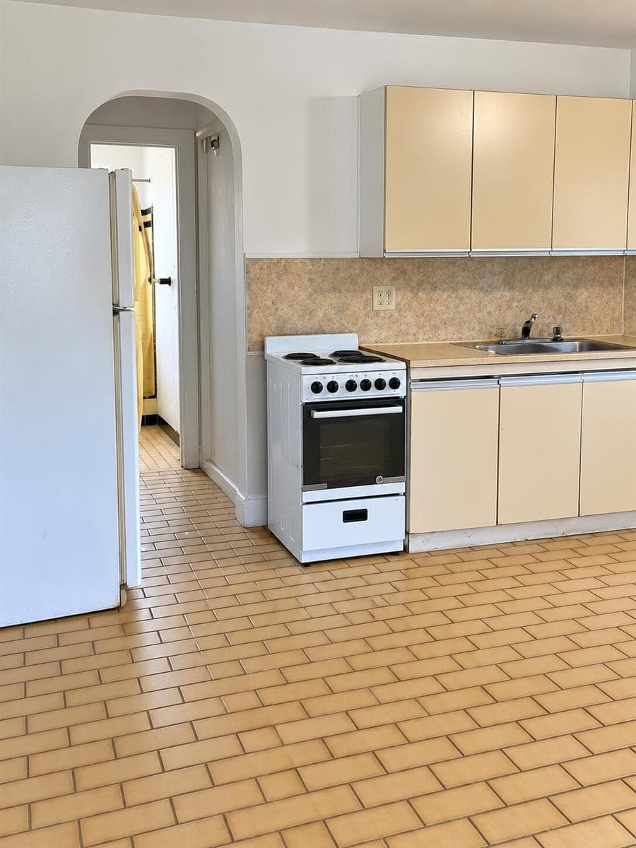 Bright Vintage Kitchen with Arched Doorw