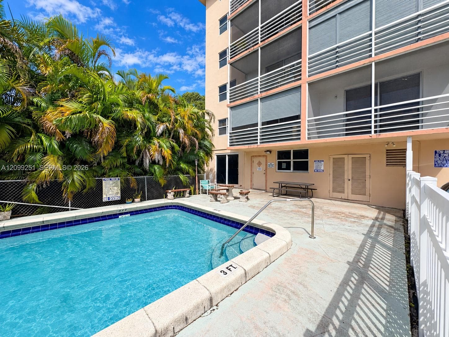 Outdoor swimming pool with integrated steps and a surrounding concrete deck