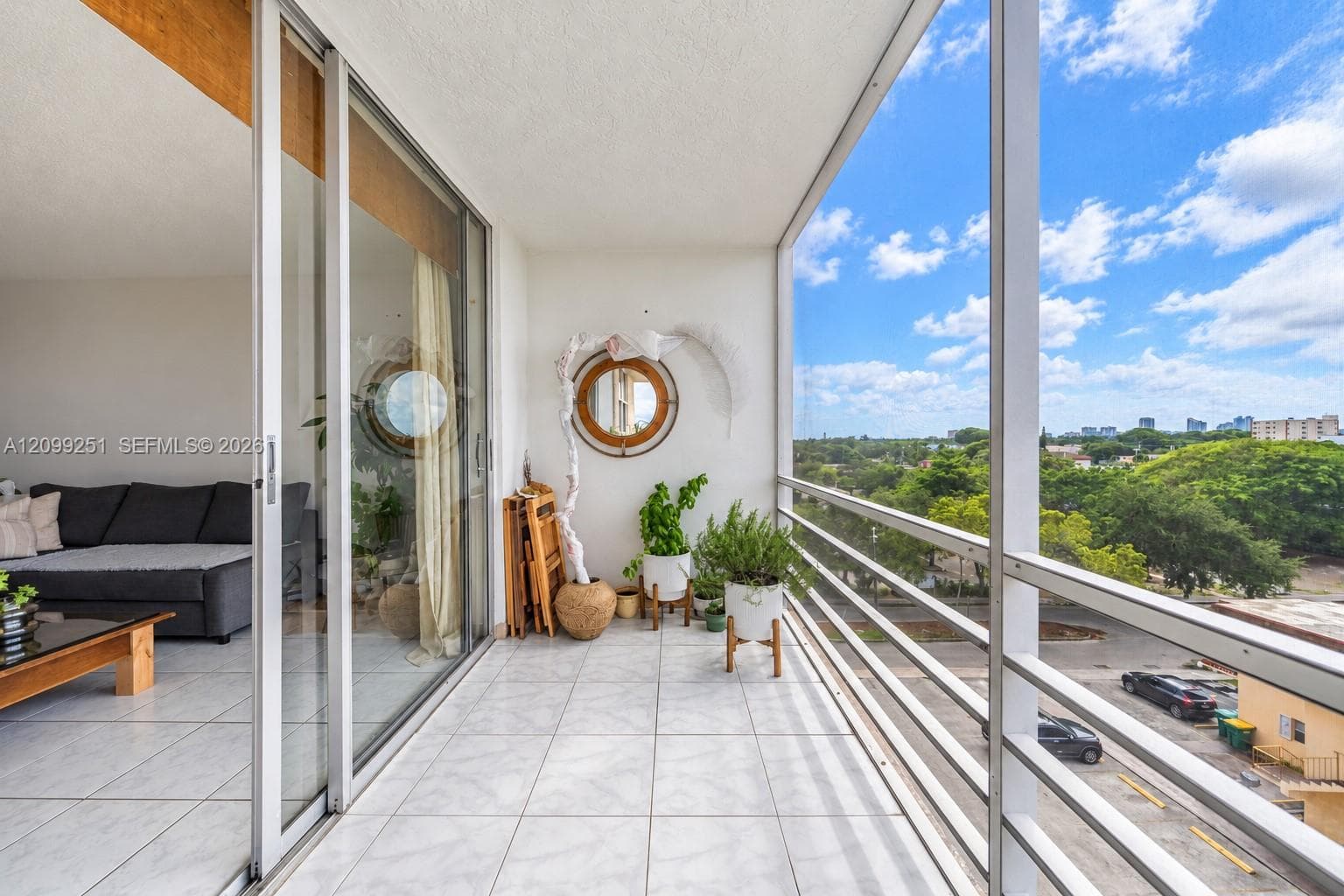 Expansive balcony with tile flooring, aluminum railing, and sliding glass doors