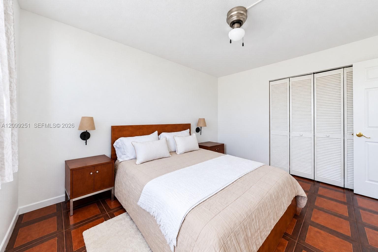 Recessed wall sconces, wood-finish flooring, ceiling fan, and bi-fold louvered closet doors