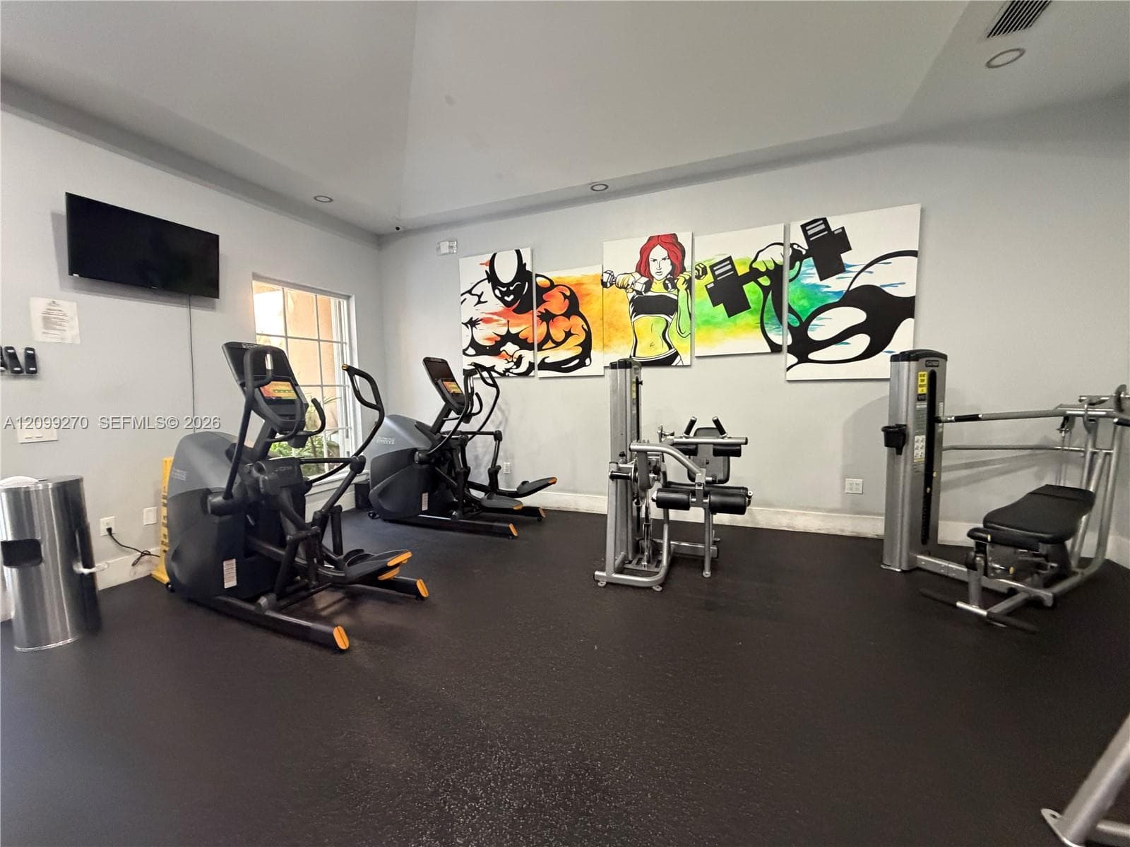 Fitness space featuring high vaulted ceilings, recessed lighting, and durable rubber flooring