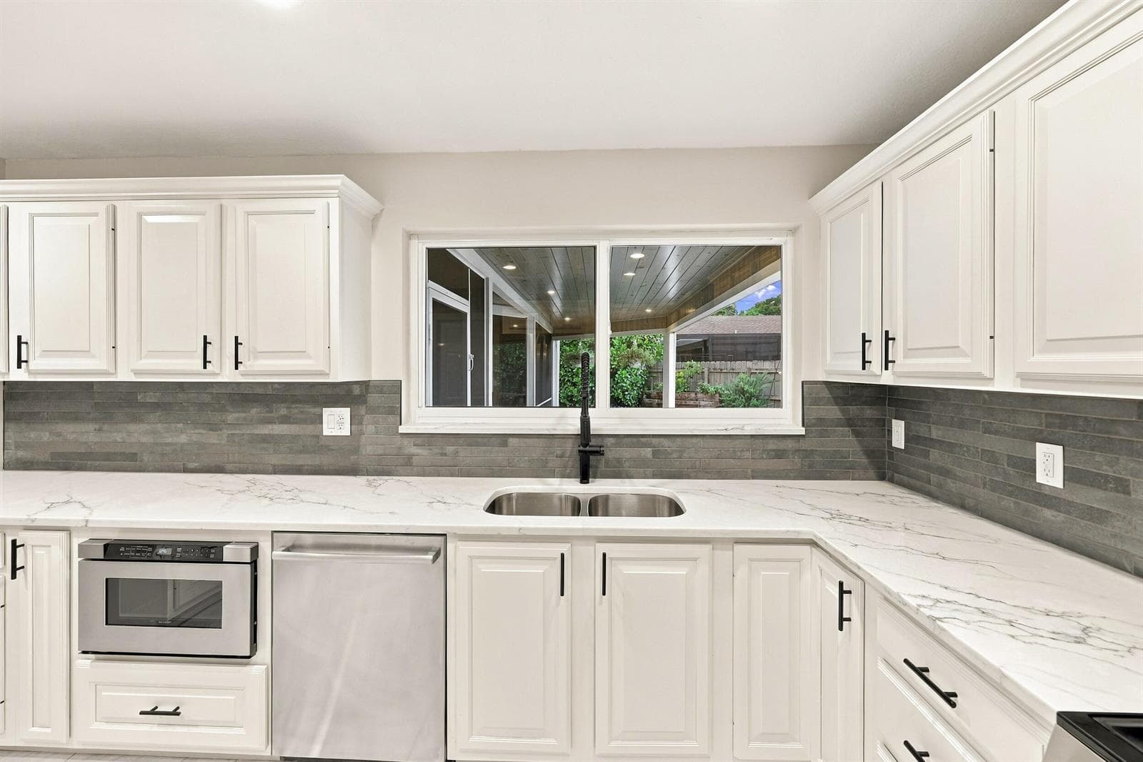 Kitchen Window Overlooks Backyard