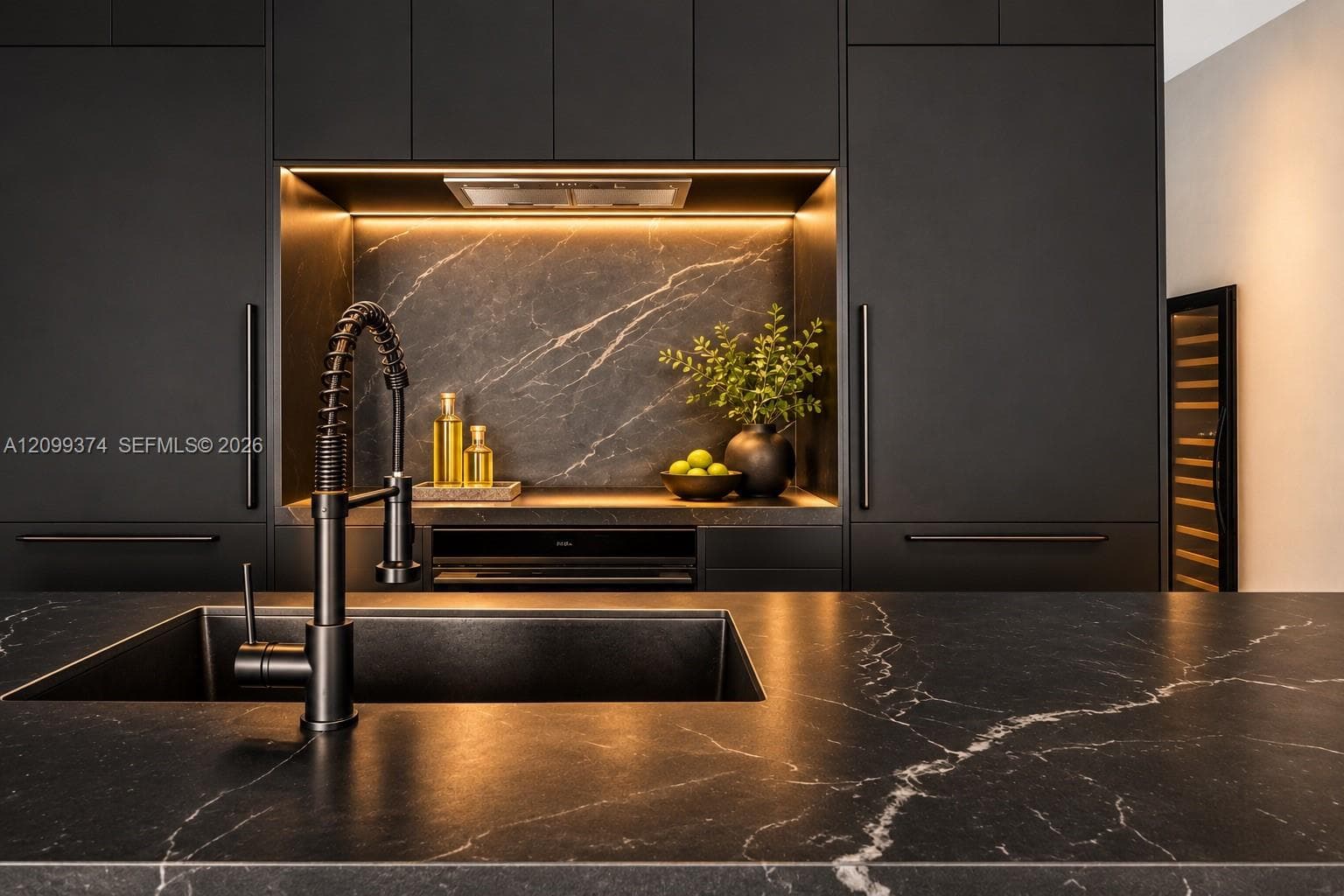 Invisible cooktop with custom stone backsplash and cabinetry