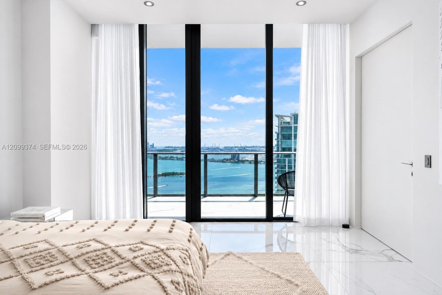 Bedroom opening toward private outdoor and water views