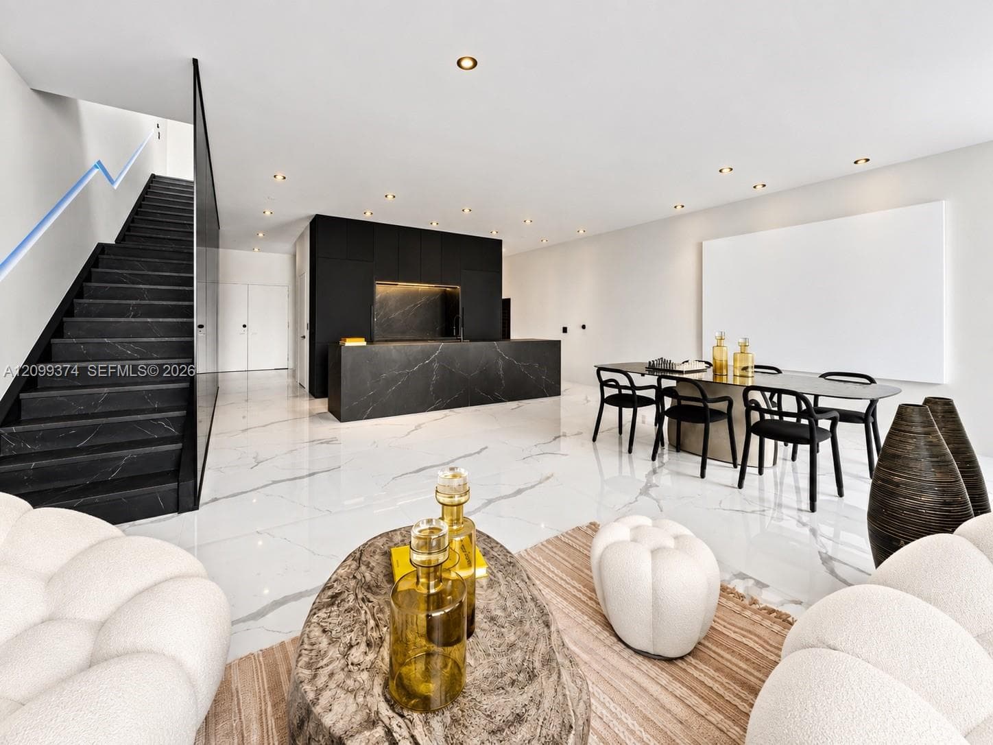 Open living area showcasing the custom staircase